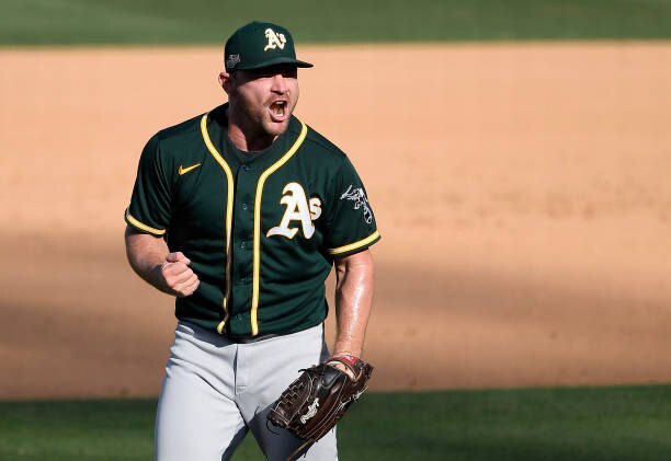 LOS ANGELES, CALIFORNIA - OCTOBER 07: Liam Hendriks #16 of the Oakland Athletics celebrates a 9-7 win against the Houston Astros in Game Three of the American League Division Series at Dodger Stadium on October 07, 2020 in Los Angeles, California. (Photo by Kevork Djansezian/Getty Images)