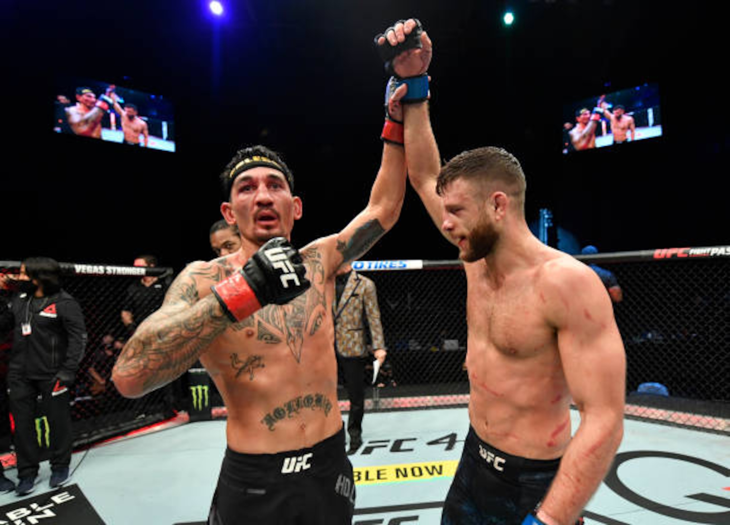 ABU DHABI, UNITED ARAB EMIRATES - JANUARY 17: (L-R) Max Holloway raises the hand of Calvin Kattar after their featherweight bout during the UFC Fight Night event at Etihad Arena on UFC Fight Island on January 17, 2021 in Abu Dhabi, United Arab Emirates. (Photo by Jeff Bottari/Zuffa LLC)