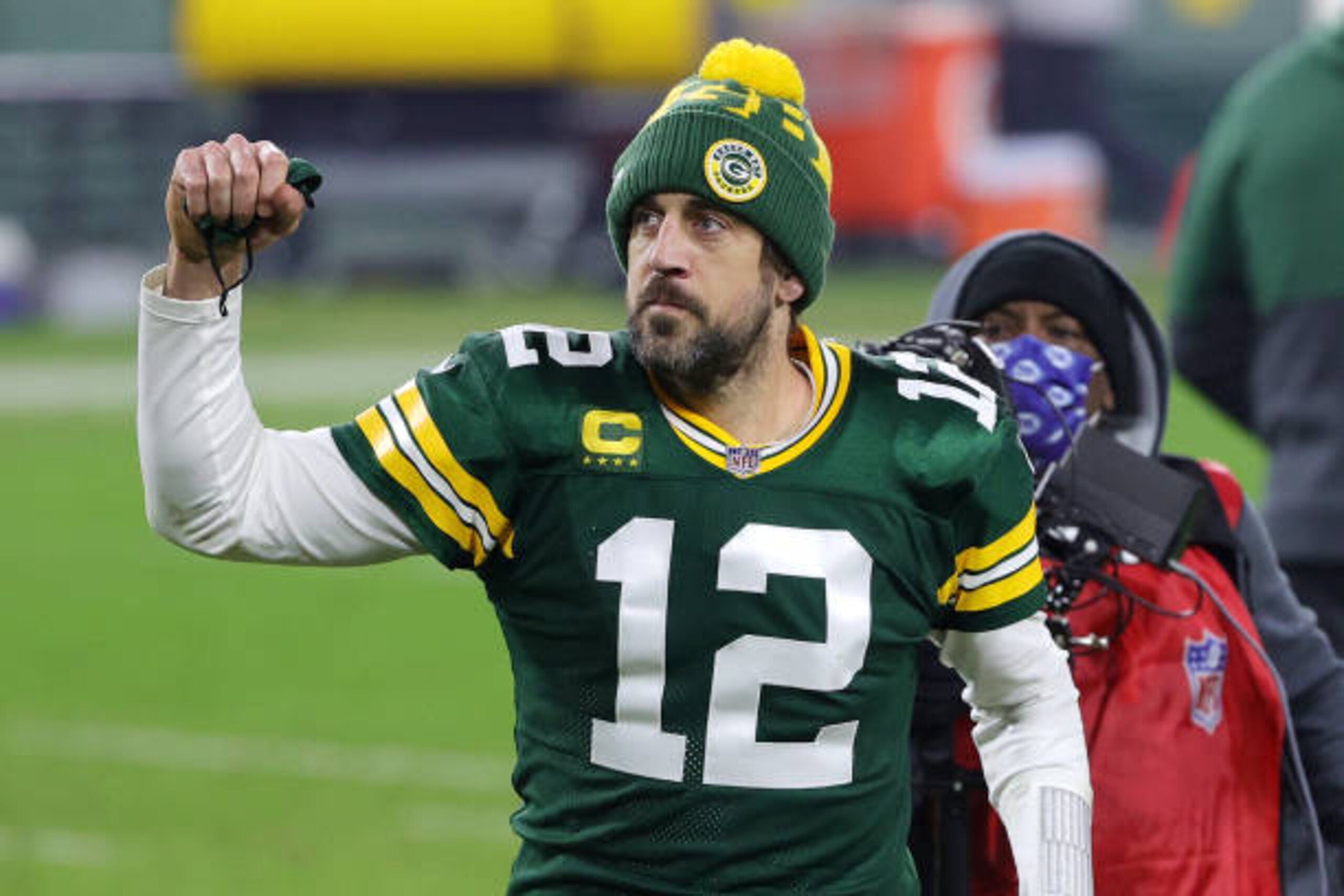 GREEN BAY, WISCONSIN - JANUARY 16: Aaron Rodgers #12 of the Green Bay Packers celebrates defeating the Los Angeles Rams 32-18 in the NFC Divisional Playoff game at Lambeau Field on January 16, 2021 in Green Bay, Wisconsin. (Photo by Stacy Revere/Getty Images)