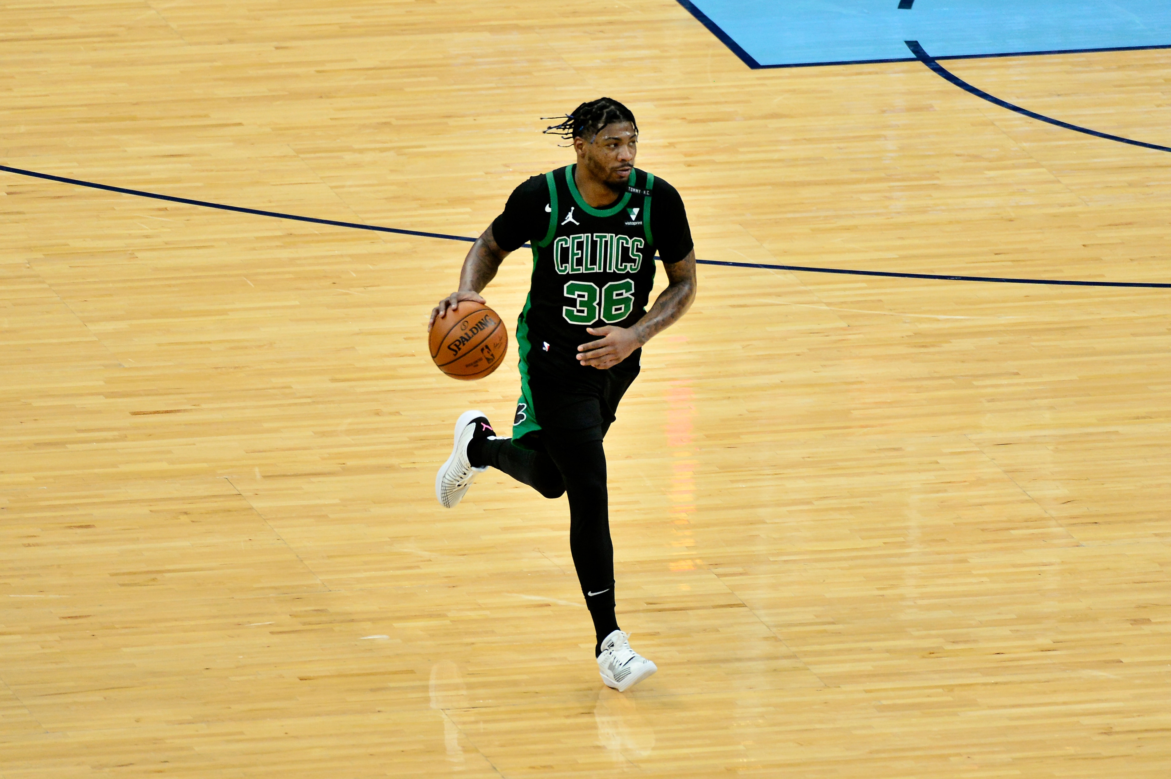 Boston Celtics guard Marcus Smart (36) brings the ball up court in the first half of an NBA basketball game against the Memphis Grizzlies Monday, March 22, 2021, in Memphis, Tenn. (AP Photo/Brandon Dill)