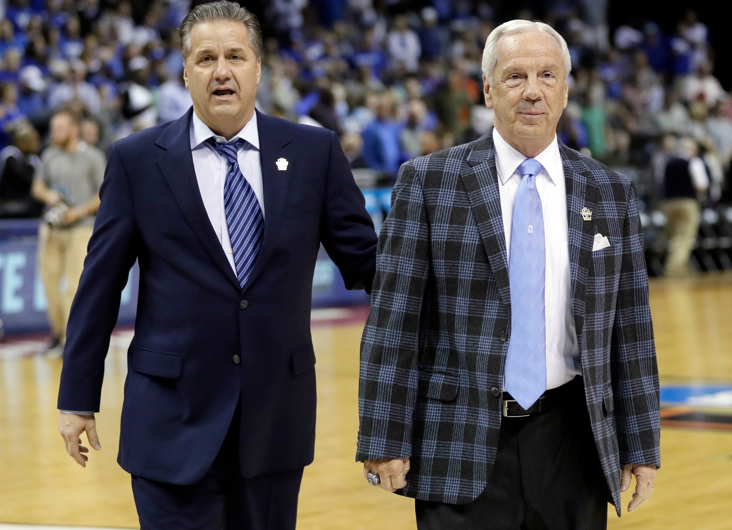 Kentucky head coach John Calipari, left, and North Carolina head coach Roy Williams speak before the first half of the South Regional final game in the NCAA college basketball tournament, Sunday, March 26, 2017, in Memphis, Tenn. (AP Photo/Mark Humphrey)