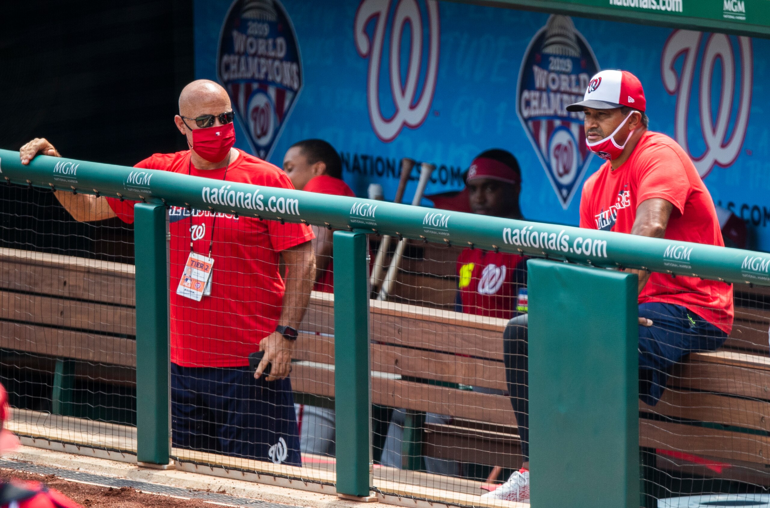 Washington Nationals manager Dave Martinez, right, with General Manager Mike Rizzo, left, watch from the dugout a baseball intrasquad game at Nationals Park, Sunday, Aug. 2, 2020, in Washington. (AP Photo/Manuel Balce Ceneta)