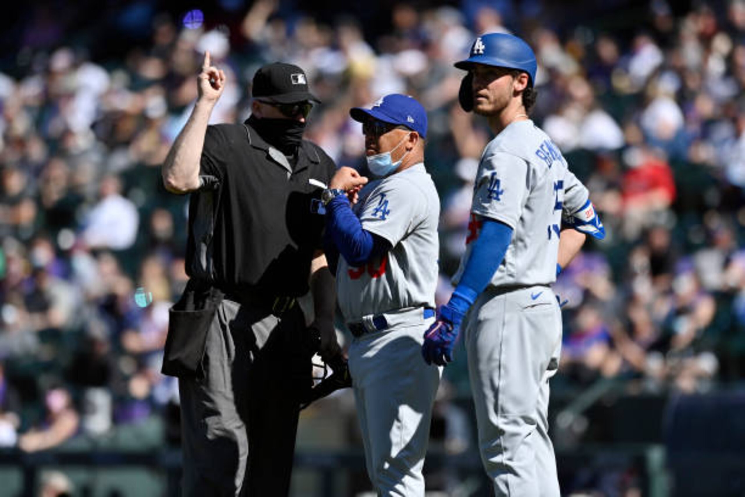 DENVER, CO - APRIL 01:  Manager Dave Roberts #30 and Cody Bellinger #35 of the Los Angeles Dodgers speak with the home plate umpire in the third inning during the game between the Los Angeles Dodgers and the Colorado Rockies at Coors Field on Thursday, April 1, 2021 in Denver, Colorado. (Photo by Dustin Bradford/MLB Photos via Getty Images)