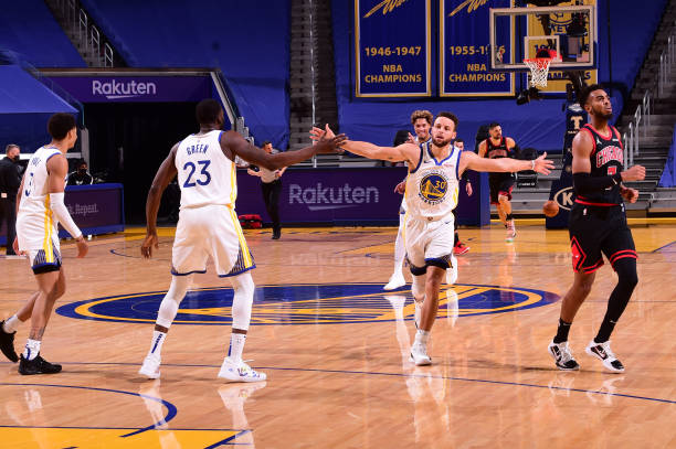 SAN FRANCISCO, CA - MARCH 29: Stephen Curry #30 hi-fives Draymond Green #23 of the Golden State Warriors during the game against the Chicago Bulls on March 29, 2021 at Chase Center in San Francisco, California. NOTE TO USER: User expressly acknowledges and agrees that, by downloading and or using this photograph, user is consenting to the terms and conditions of Getty Images License Agreement. Mandatory Copyright Notice: Copyright 2021 NBAE (Photo by Noah Graham/NBAE via Getty Images)