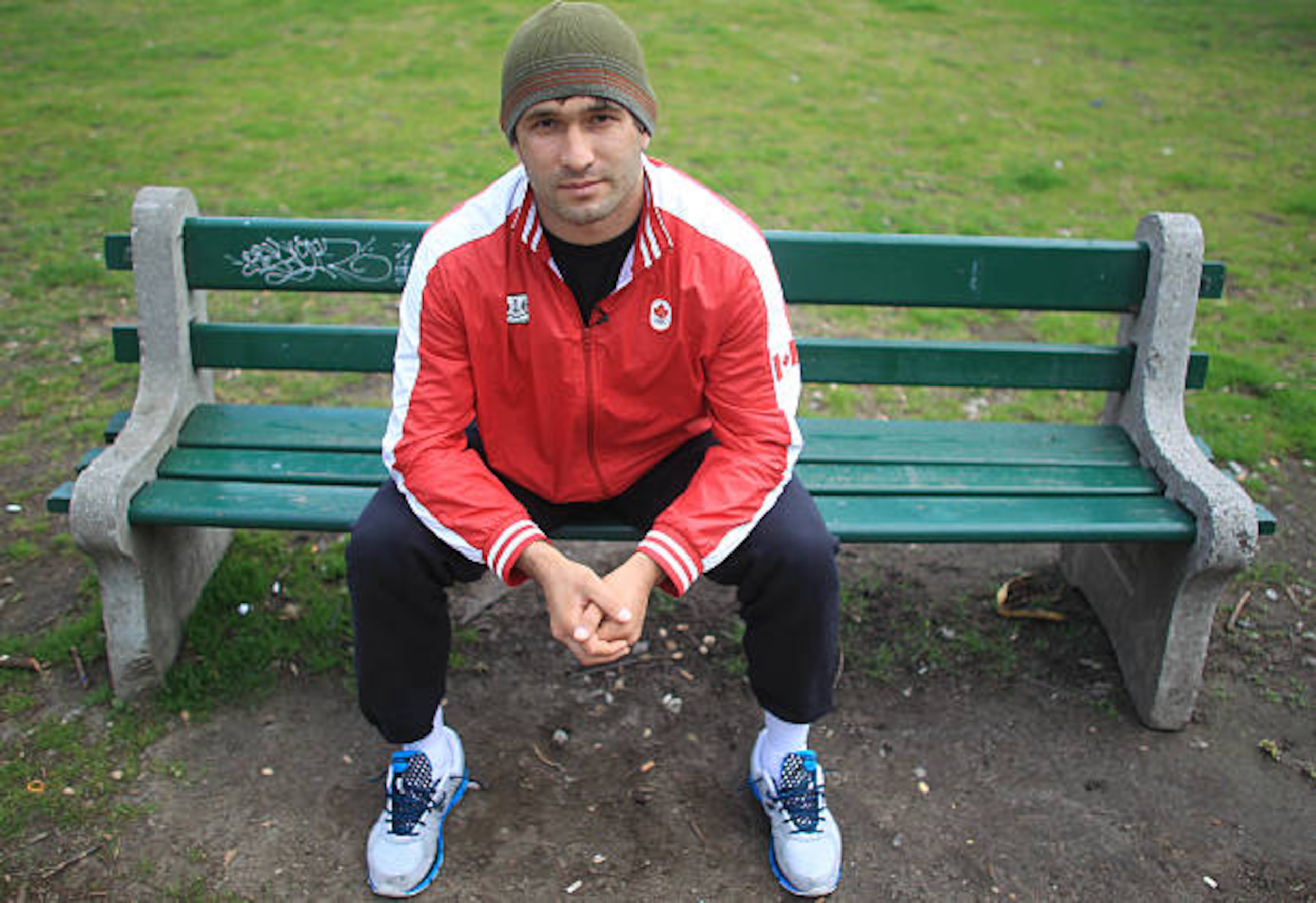 Canadian Olympic wrestler Khetag Pliev visits one of the benches at Allan Gardens that he used to sleep on. Originally from Russia the 96 kg wrestler was so down and out when he arrived in this country that he slept on park benches in Toronto. April 16, 2012. STEVE RUSSELL/TORONTO STAR (Photo by Steve Russell/Toronto Star via Getty Images)