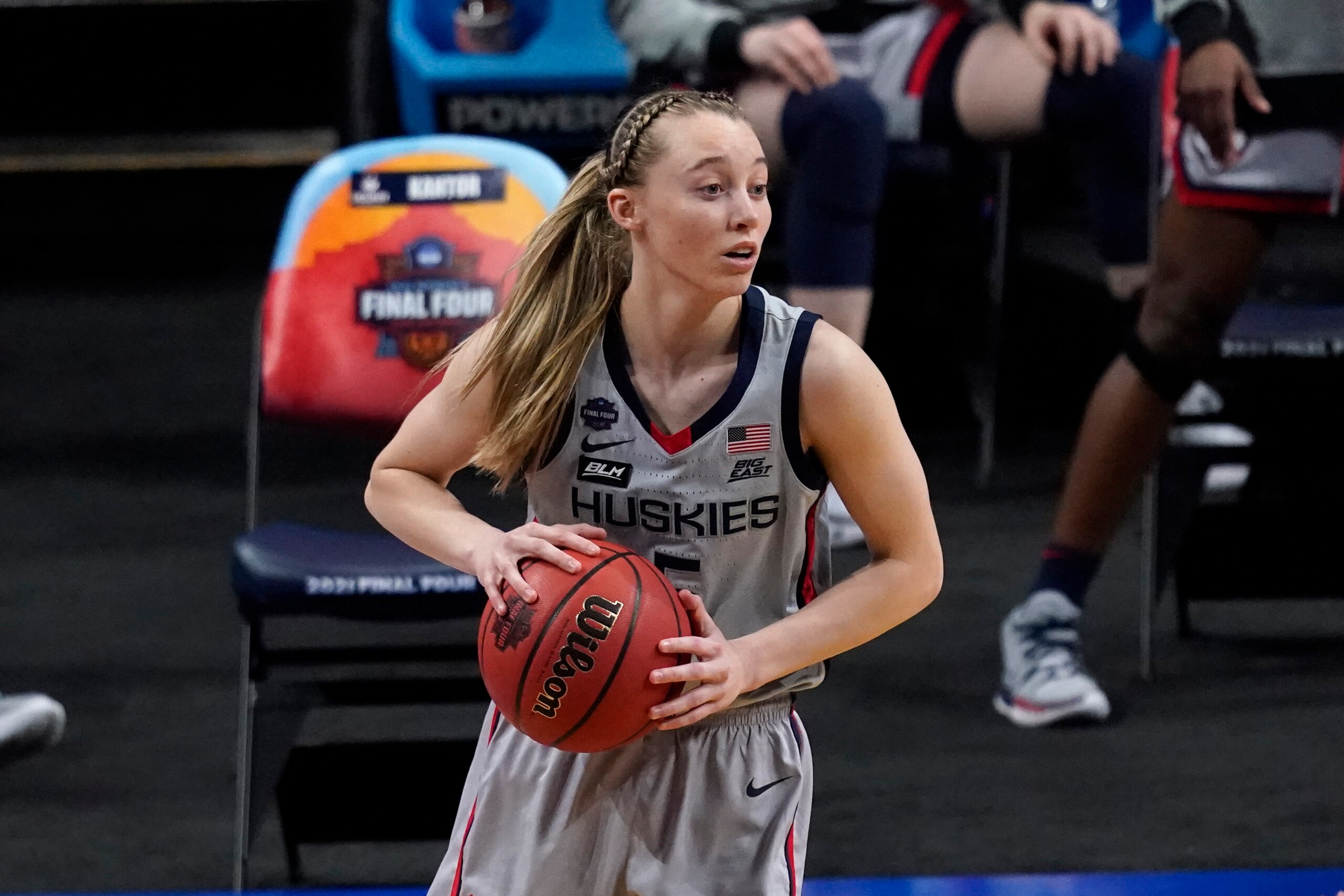 Connecticut guard Paige Bueckers (5) looks to pass up court during the first half of a women's Final Four NCAA college basketball tournament semifinal game against Arizona Friday, April 2, 2021, at the Alamodome in San Antonio. (AP Photo/Eric Gay)