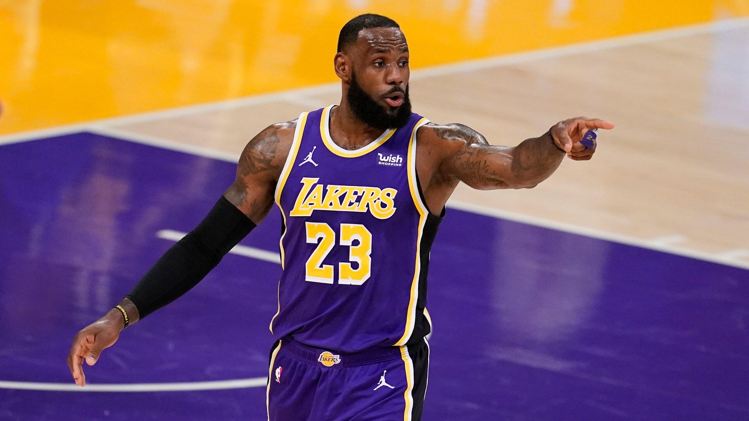 Los Angeles Lakers forward LeBron speaks to a teammate during an NBA basketball game against the Charlotte Hornets Thursday, March 18, 2021, in Los Angeles. (AP Photo/Marcio Jose Sanchez)