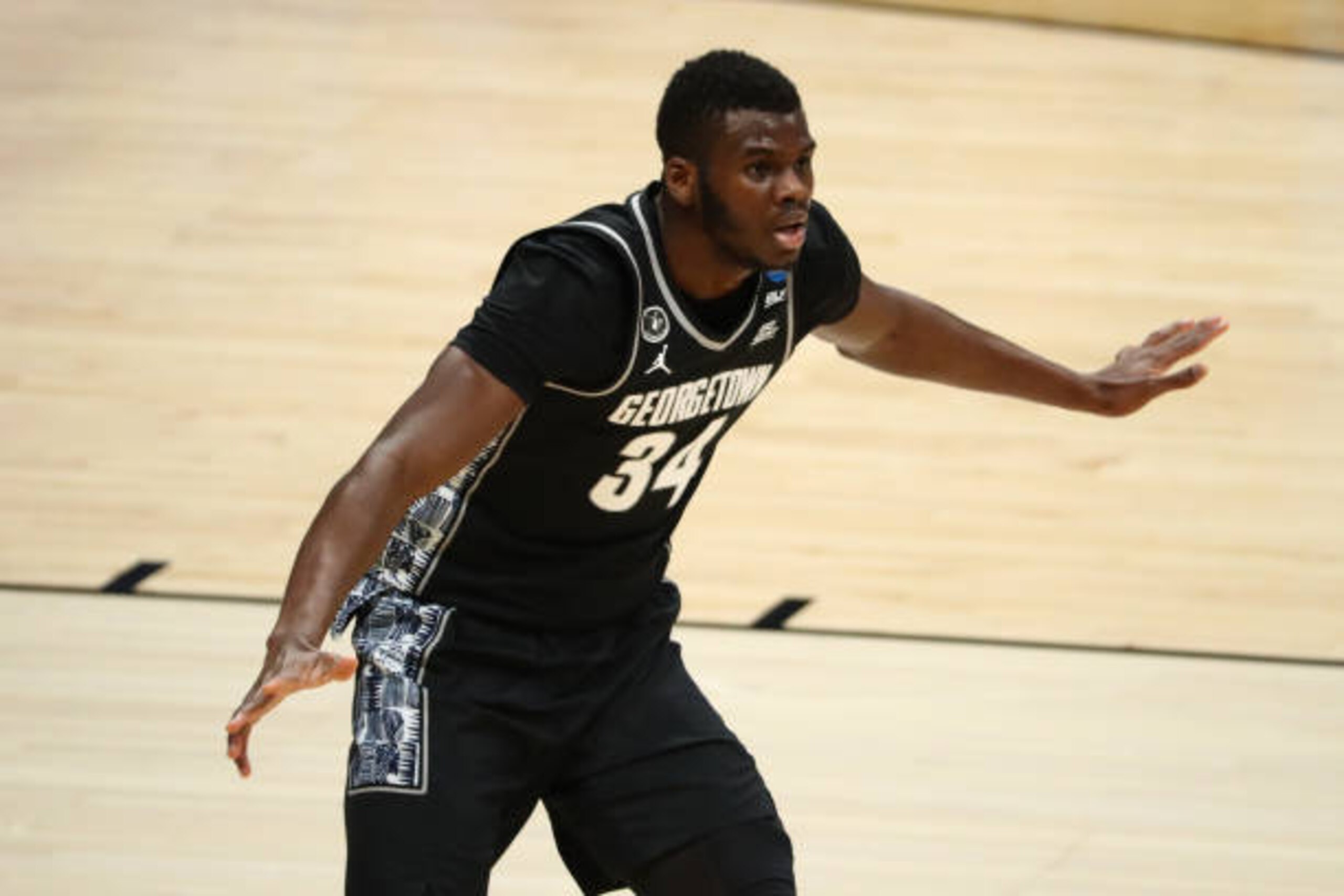 INDIANAPOLIS, IN - MARCH 20: Qudus Wahab #34 of the Georgetown Hoyas set up on the defensive end against the Colorado Buffaloes during the second half in the first round of the 2021 NCAA Division I Mens Basketball Tournament held at Hinkle Fieldhouse on March 20, 2021 in Indianapolis, Indiana. (Photo by C. Morgan Engel/NCAA Photos via Getty Images)