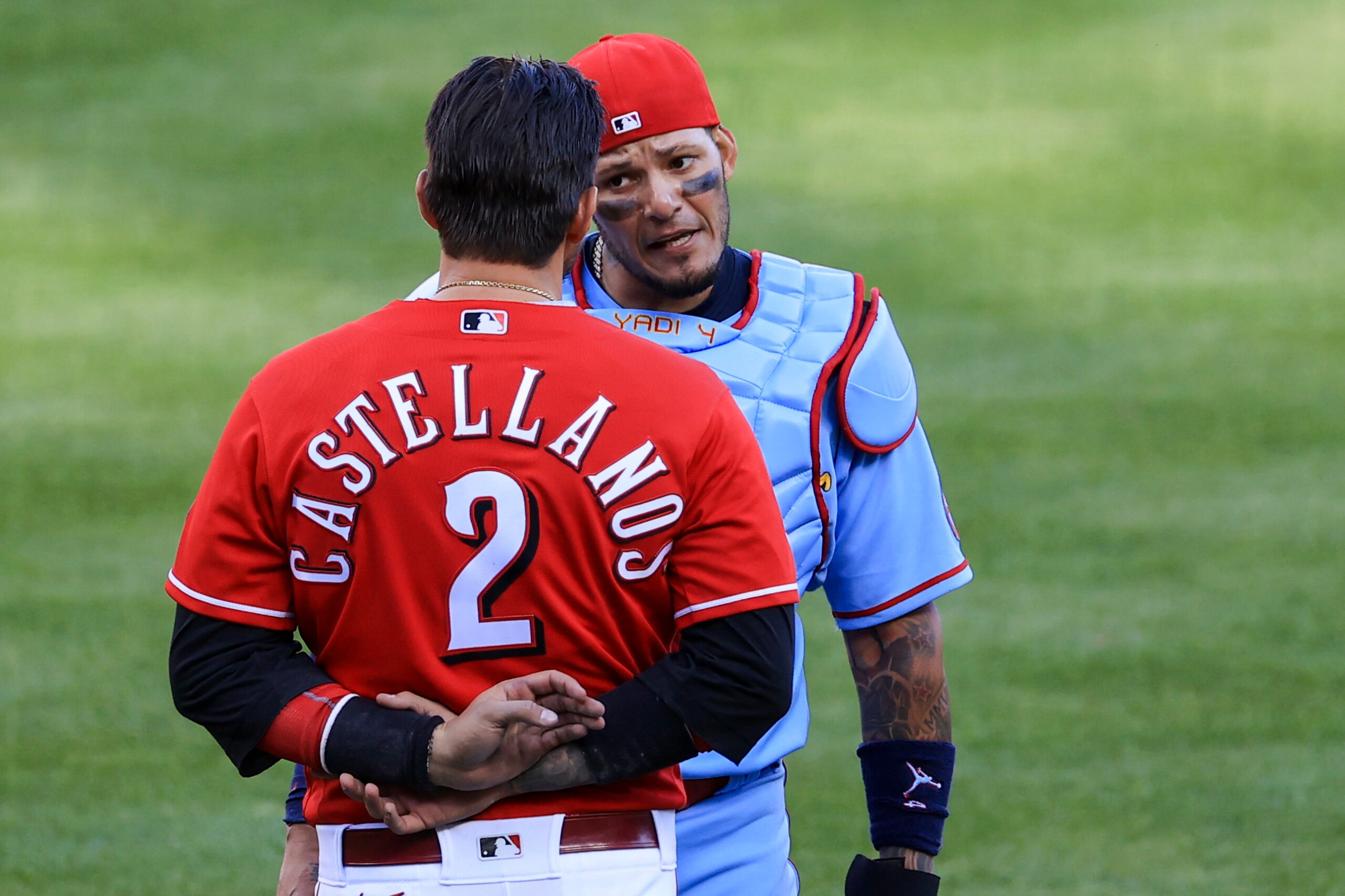 Cincinnati Reds' Nick Castellanos talks with St. Louis Cardinals' Yadier Molina after benches clear during a baseball game in Cincinnati, Saturday, April 3, 2021. The Reds won 9-6. (AP Photo/Aaron Doster)
