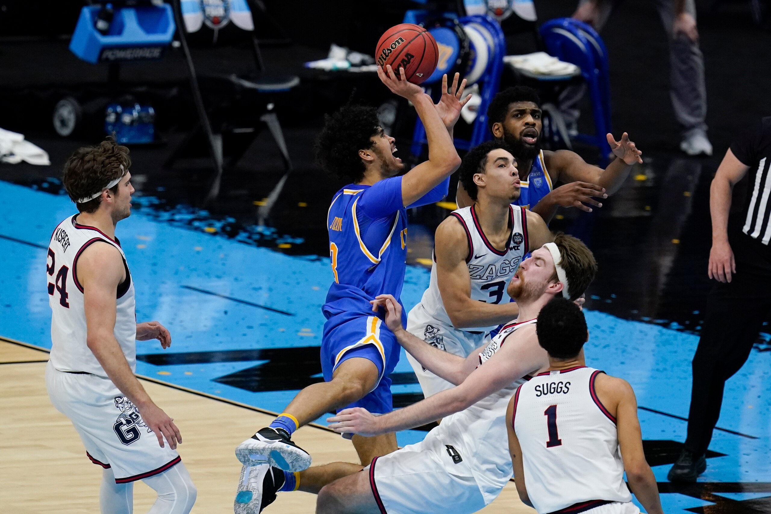 UCLA guard Johnny Juzang (3) drives to the basket over Gonzaga forward Drew Timme (2) during the second half of a men's Final Four NCAA college basketball tournament semifinal game, Saturday, April 3, 2021, at Lucas Oil Stadium in Indianapolis. Juzang was called for charging. (AP Photo/Michael Conroy)