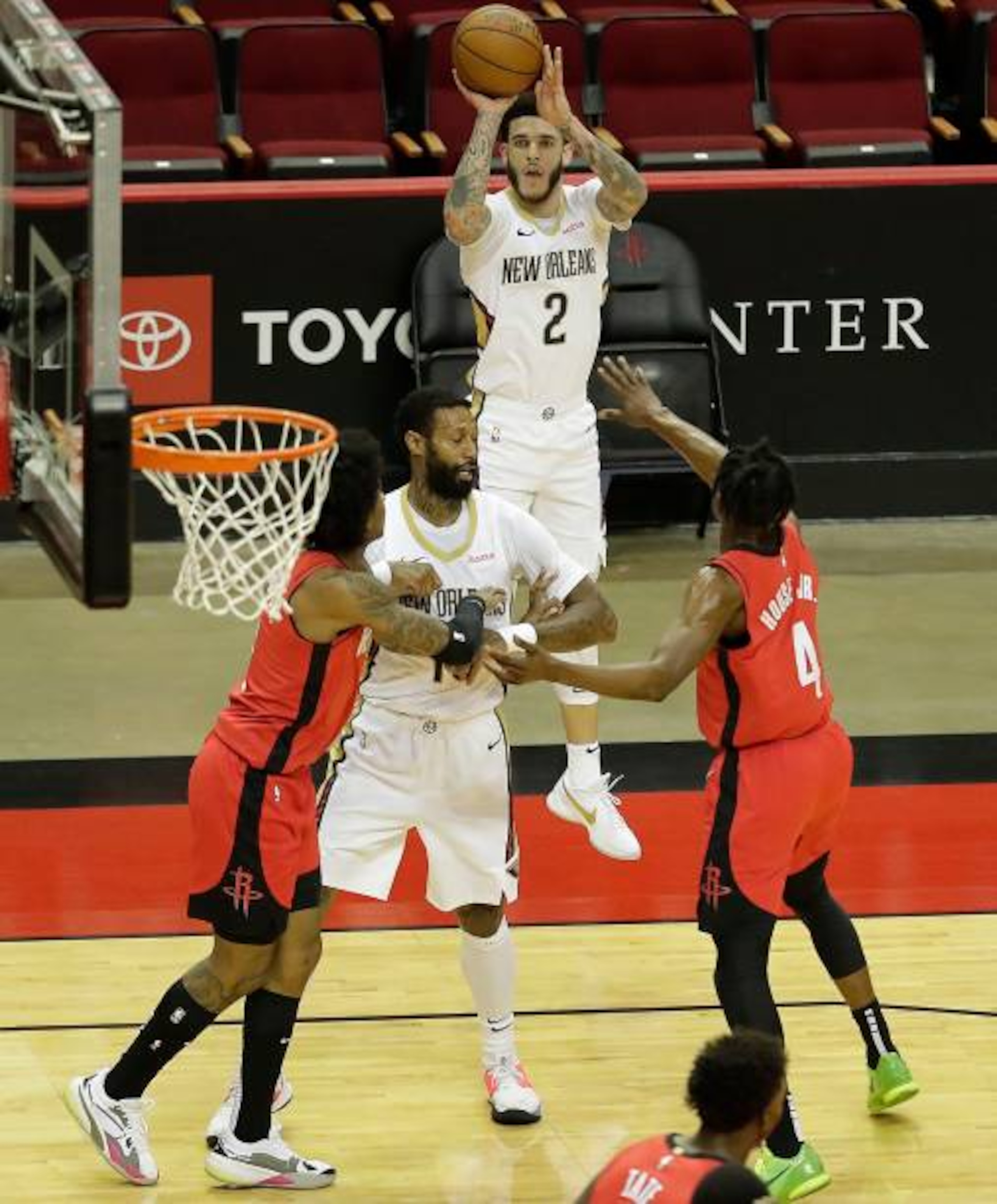 HOUSTON, TEXAS - APRIL 04: Lonzo Ball #2 of the New Orleans Pelicans shoot a three point basket over Danuel House Jr. #4 of the Houston Rockets during the first quarter at Toyota Center on April 04, 2021 in Houston, Texas. NOTE TO USER: User expressly acknowledges and agrees that, by downloading and or using this photograph, User is consenting to the terms and conditions of the Getty Images License Agreement. (Photo by Bob Levey/Getty Images)