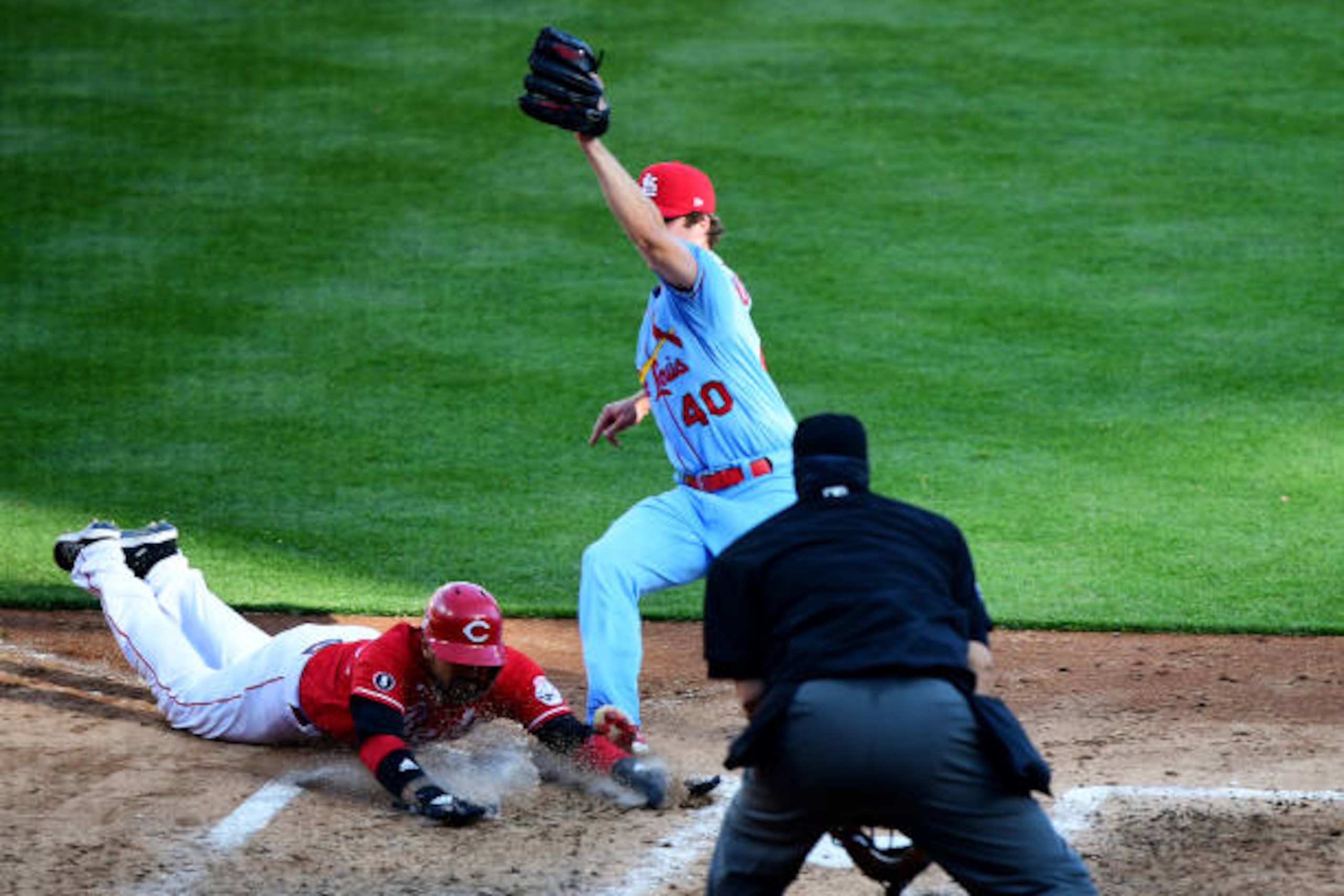CINCINNATI, OHIO - APRIL 03: Nick Castellanos #2 of the Cincinnati Reds slides safely into home base against Jake Woodford #40 of the St. Louis Cardinals in the fourth inning at Great American Ball Park on April 03, 2021 in Cincinnati, Ohio. (Photo by Emilee Chinn/Getty Images)