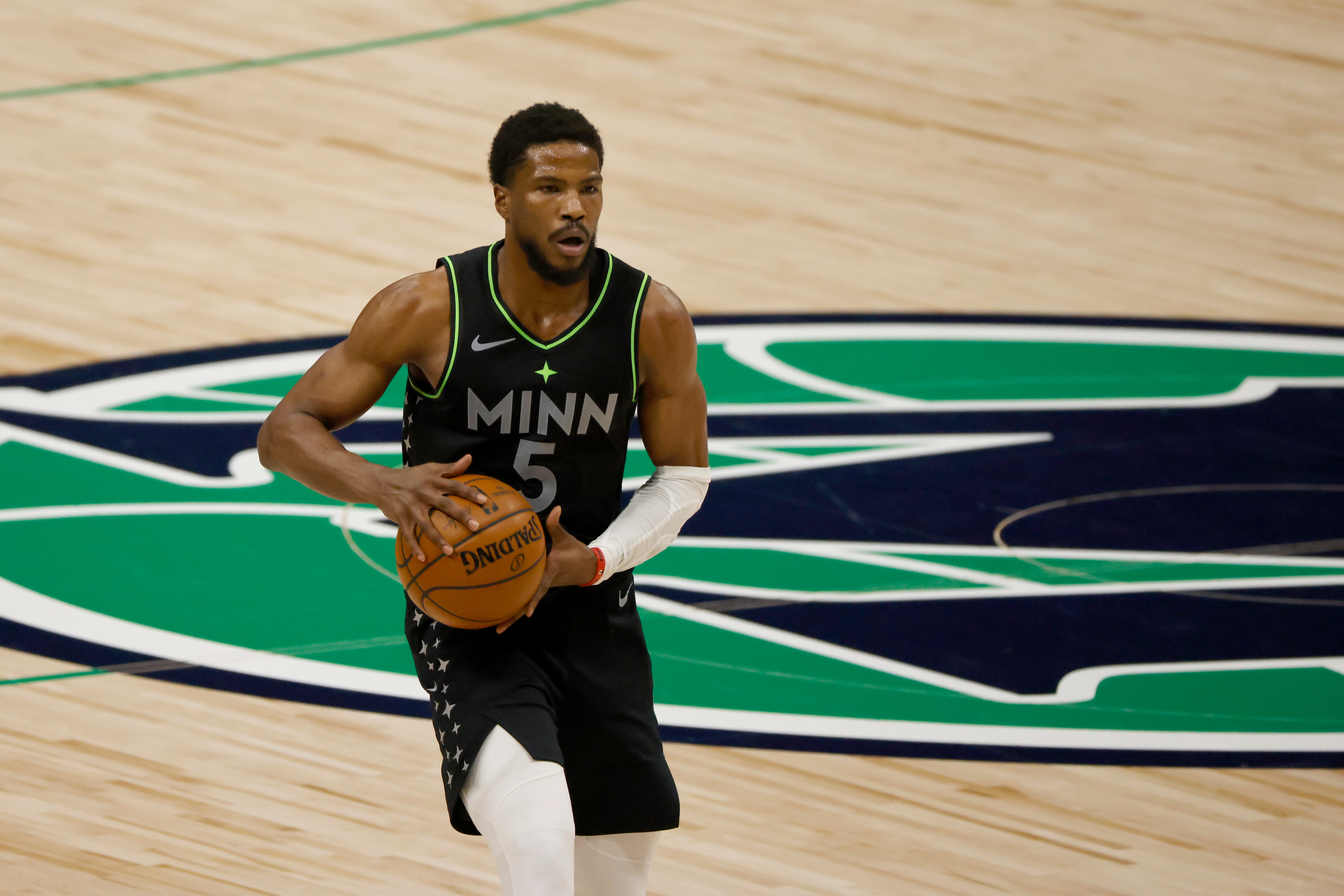 Minnesota Timberwolves guard Malik Beasley (5) handles the ball against the Dallas Mavericks during the second half of an NBA basketball game, Monday, Feb. 8, 2021, in Dallas. (AP Photo/Ron Jenkins)