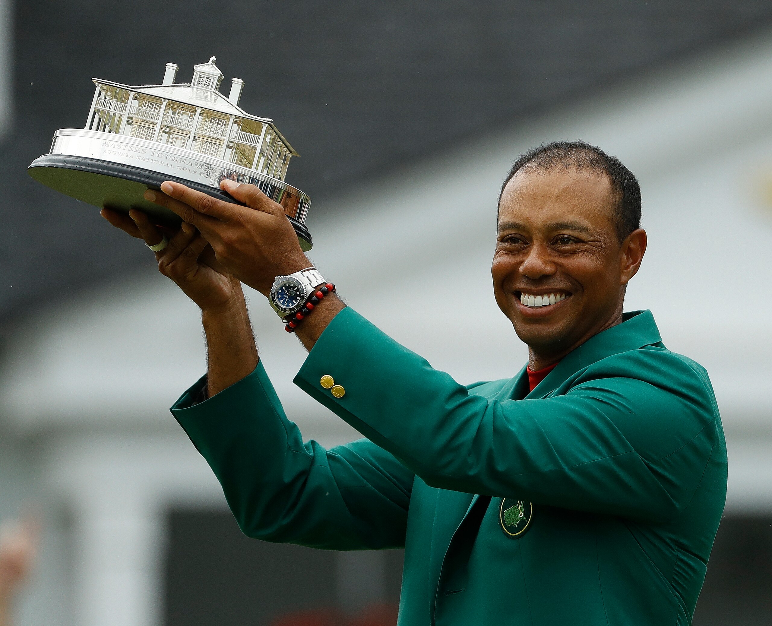 Tiger Woods wears his green jacket holding the winning trophy after the final round for the Masters golf tournament Sunday, April 14, 2019, in Augusta, Ga. (AP Photo/Matt Slocum)