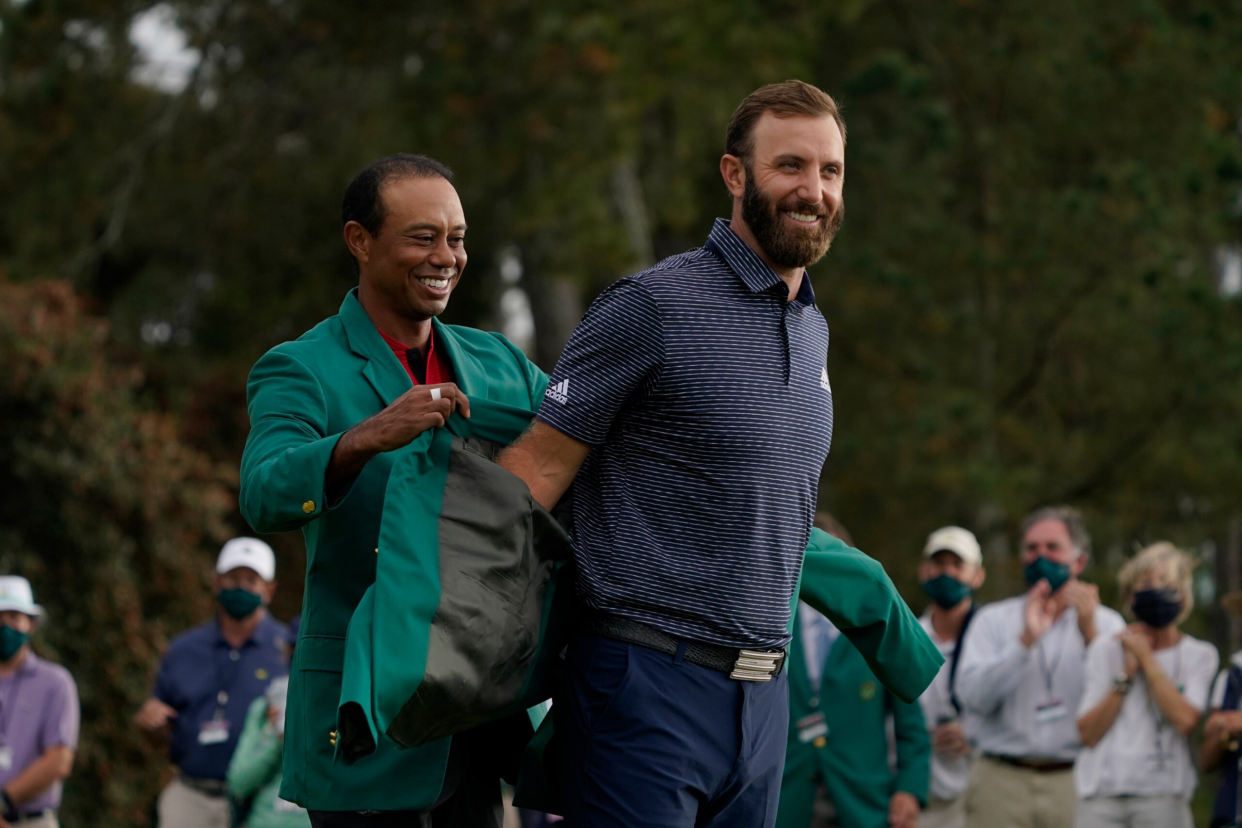 Tiger Woods, left and Dustin Johnson during the final round of the Masters golf tournament Monday, Nov. 16, 2020, in Augusta, Ga. (AP Photo/Charlie Riedel)