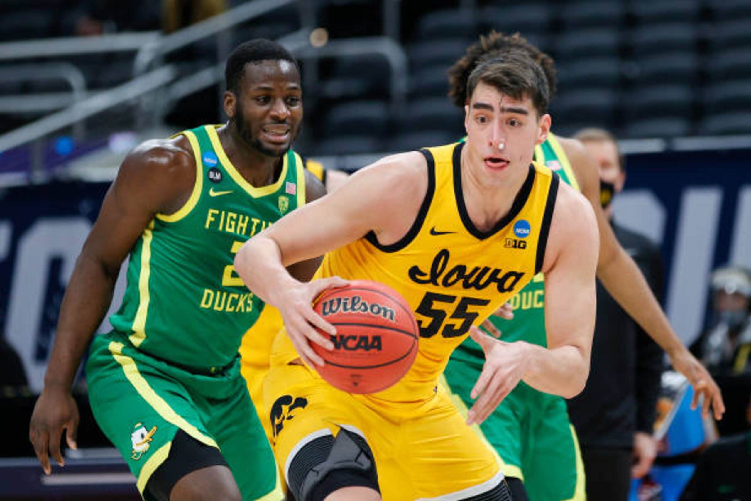 INDIANAPOLIS, INDIANA - MARCH 22: Luka Garza #55 of the Iowa Hawkeyes handles the ball defended by Eugene Omoruyi #2 of the Oregon Ducks in the second round game of the 2021 NCAA Men's Basketball Tournament at Bankers Life Fieldhouse on March 22, 2021 in Indianapolis, Indiana. (Photo by Sarah Stier/Getty Images) INDIANAPOLIS, INDIANA - MARCH 22: Luka Garza #55 of the Iowa Hawkeyes handles the ball defended by Eugene Omoruyi #2 of the Oregon Ducks in the second round game of the 2021 NCAA Men's Basketball Tournament at Bankers Life Fieldhouse on March 22, 2021 in Indianapolis, Indiana. (Photo by Sarah Stier/Getty Images)