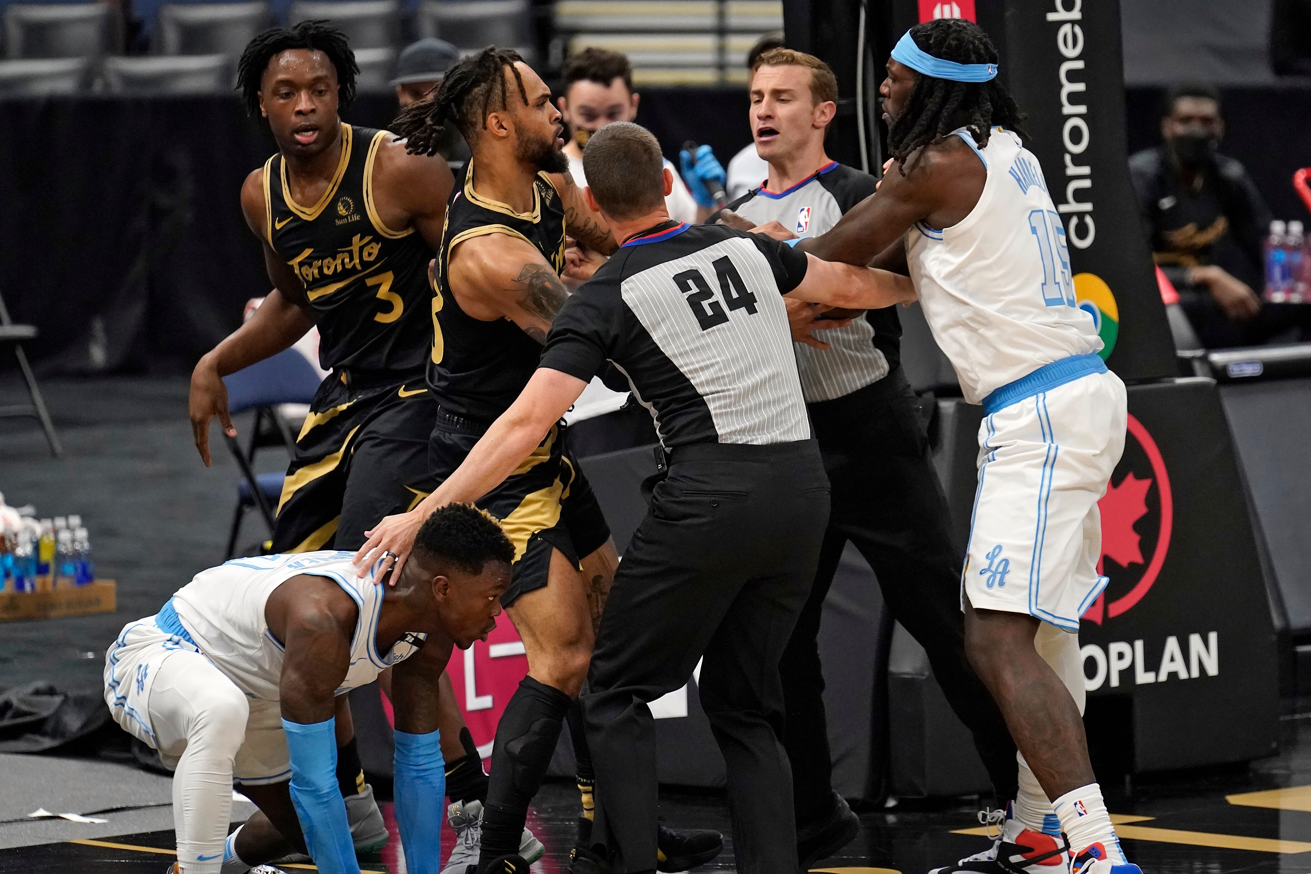 RETRANSMISSION TO CORRECT LAKERS PLAYER WHO WAS EJECTED TO MONTREZL HARRELL - Los Angeles Lakers center Montrezl Harrell (15) and Toronto Raptors guard Gary Trent Jr. (33) exchange shoves after Raptors' OG Anunoby (3) threw Lakers' Dennis Schroder (17) to the floor after a foul during the first half of an NBA basketball game Tuesday, April 6, 2021, in Tampa, Fla. Toronto Raptors OG Anunoby and Los Angeles Lakers Montrezl Harrell were ejected. (AP Photo/Chris O'Meara)