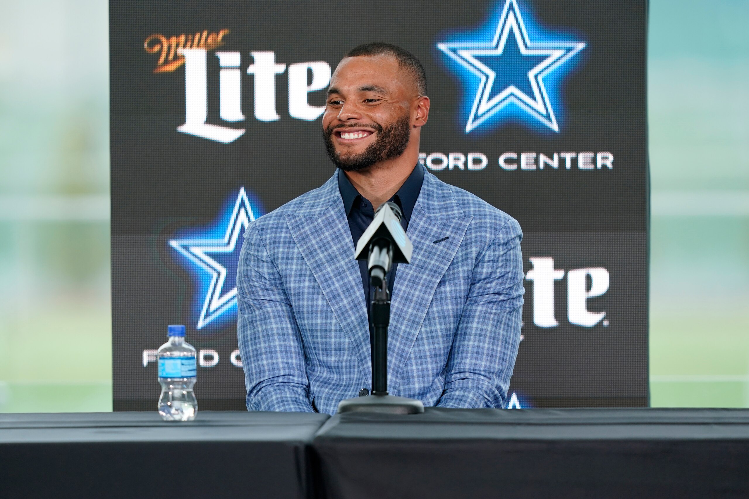 Dallas Cowboys quarterback Dak Prescott smiles during a news conference at the team's NFL football practice facility in Frisco, Texas, Wednesday, March 10, 2021. The Cowboys and Prescott have finally agreed on the richest contract in club history, two years after negotiations began with the star quarterback. (AP Photo/LM Otero)