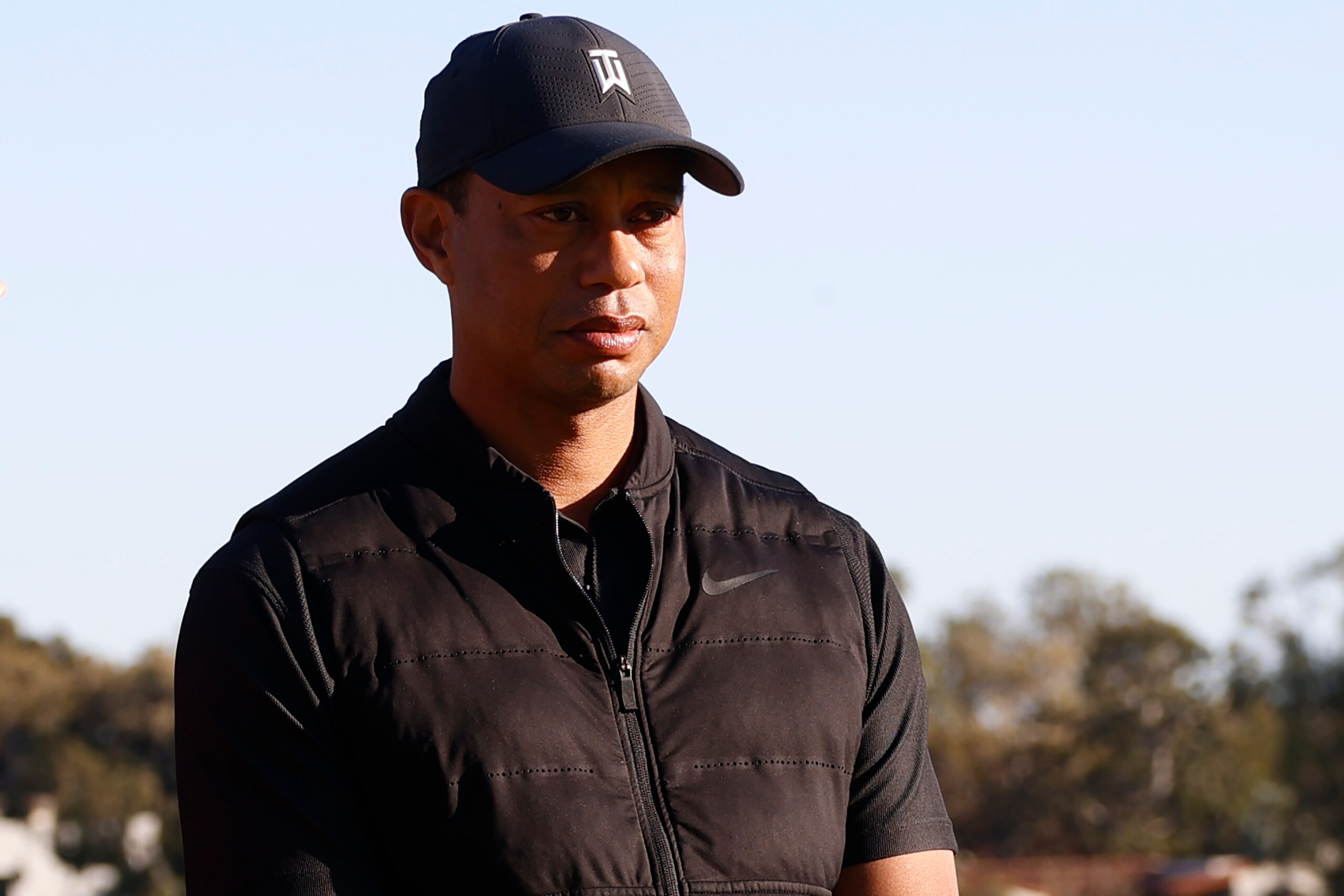 Tiger Woods looks on during the trophy ceremony on the practice green after the final round of the Genesis Invitational golf tournament at Riviera Country Club, Sunday, Feb. 21, 2021, in the Pacific Palisades area of Los Angeles. (AP Photo/Ryan Kang)