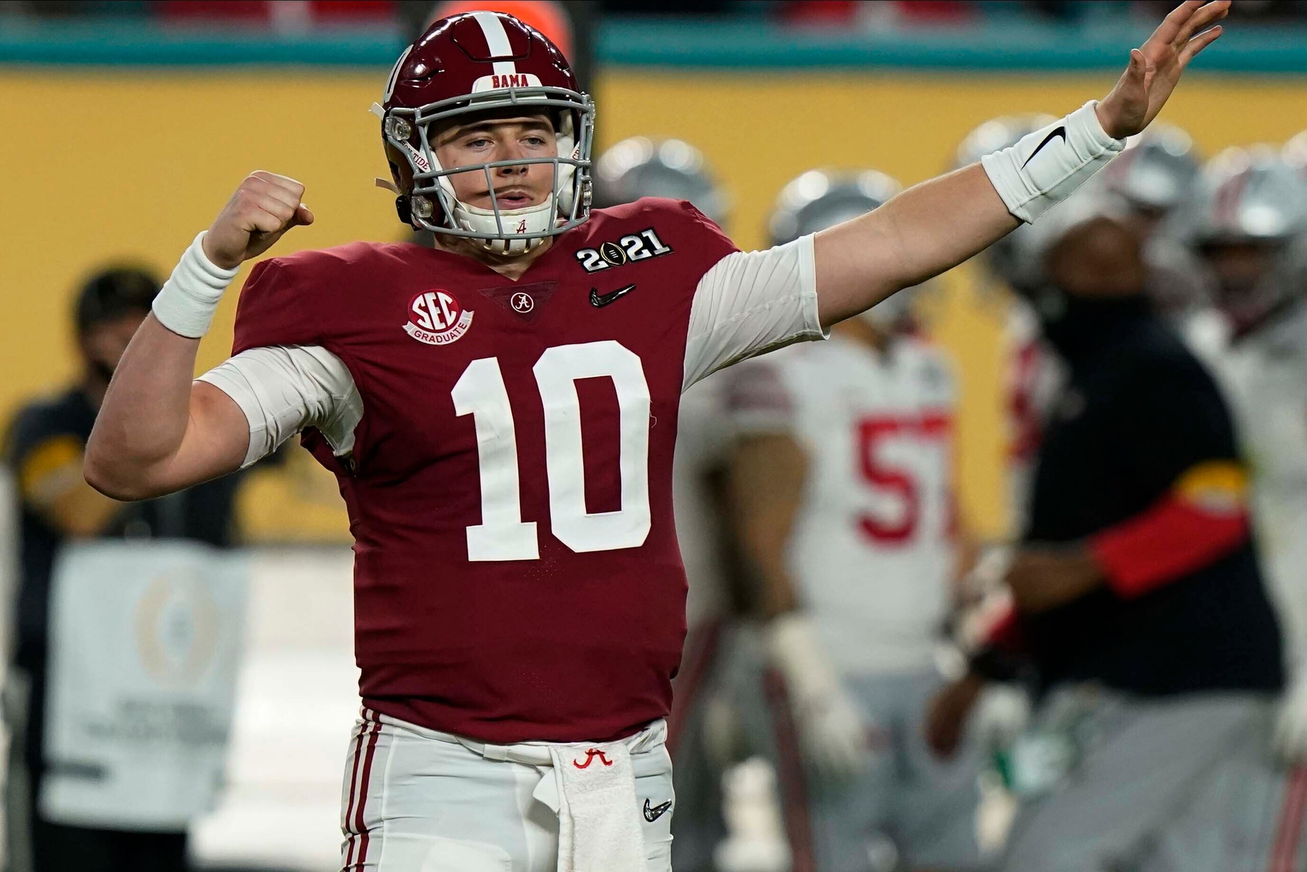 Alabama quarterback Mac Jones celebrates after a touchdown by wide receiver DeVonta Smith during the first half of an NCAA College Football Playoff national championship game against Ohio State, Monday, Jan. 11, 2021, in Miami Gardens, Fla. (AP Photo/Lynne Sladky)
