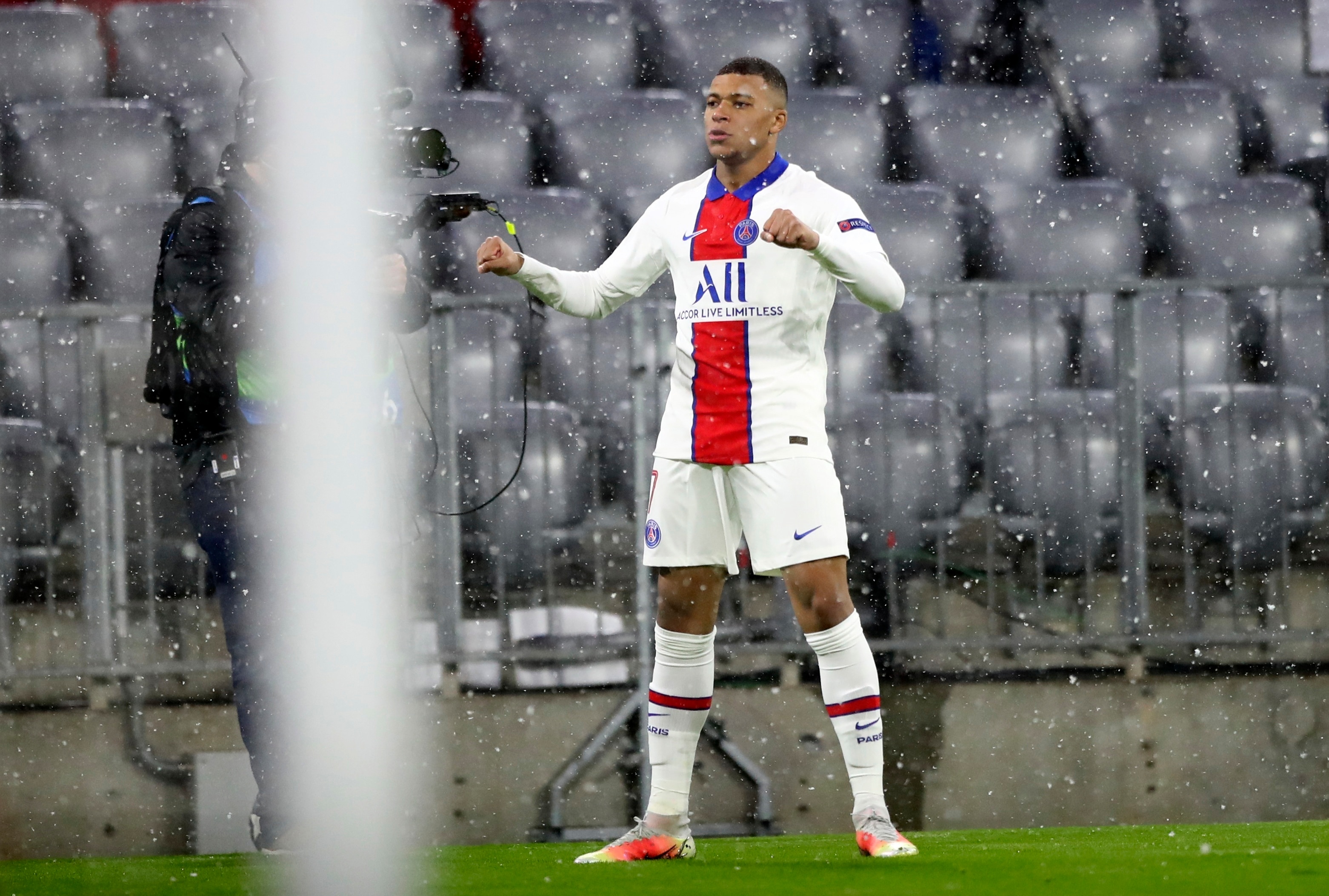 PSG's Kylian Mbappe celebrates after scoring the opening goal of his team during the Champions League quarterfinal soccer match between Bayern Munich and Paris Saint Germain in Munich, Germany, Wednesday, April 7, 2021. (AP Photo/Matthias Schrader)