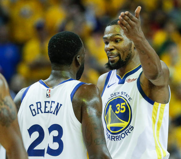 Golden State Warriors Kevin Durant and Draymond Green react after a Durant dunk in the third quarter during game 1 of the Western Conference Semifinals between the Golden State Warriors and the Houston Rockets at Oracle Arena on Sunday, April 28, 2019 in Oakland, Calif. (Photo by Carlos Avila Gonzalez/San Francisco Chronicle via Getty Images)