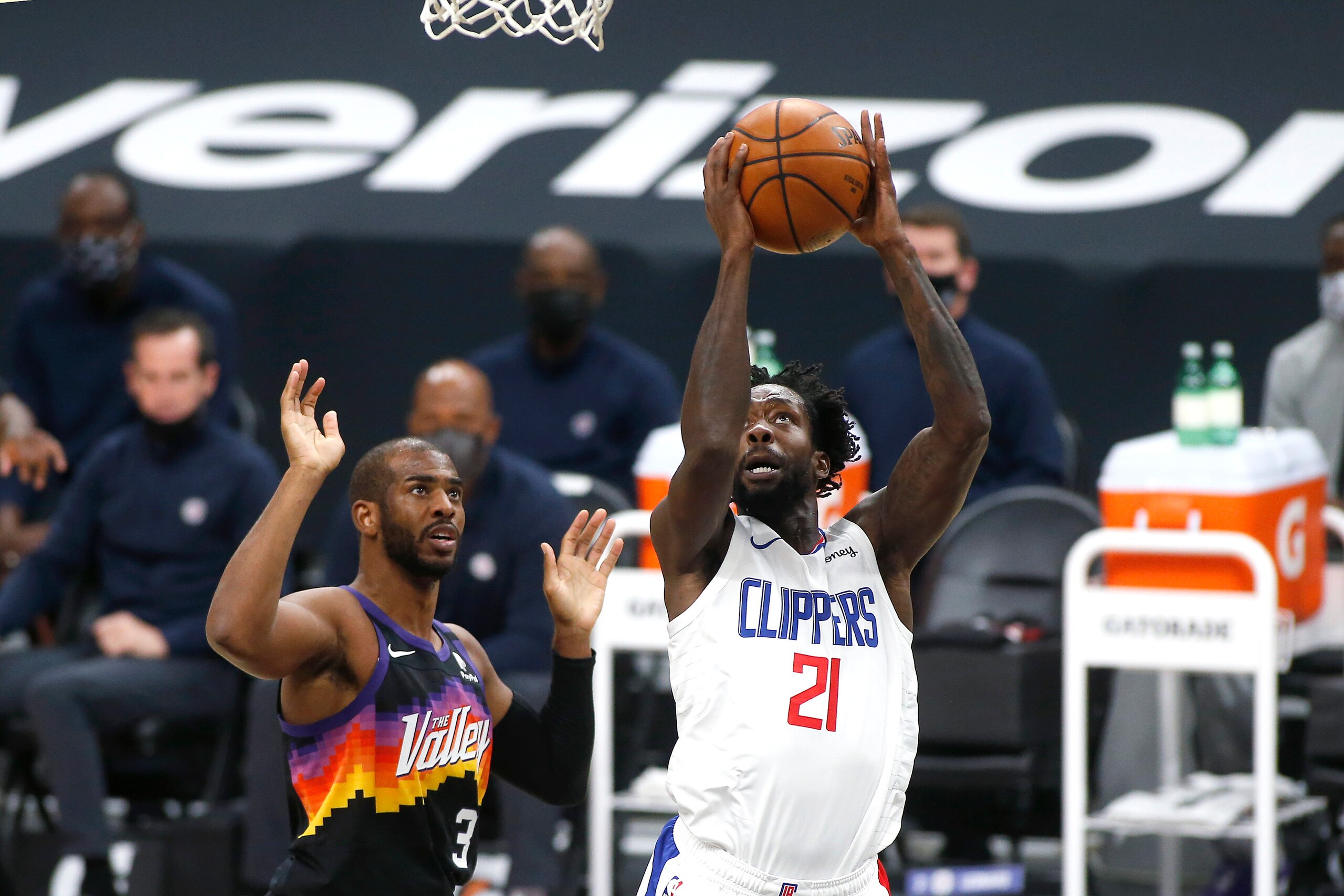 Los Angeles Clippers guard Patrick Beverley (21) shoots past the defense of Phoenix Suns guard Chris Paul (3) during the first half of an NBA basketball game Sunday, Jan. 3, 2021, in Phoenix. (AP Photo/Ralph Freso)