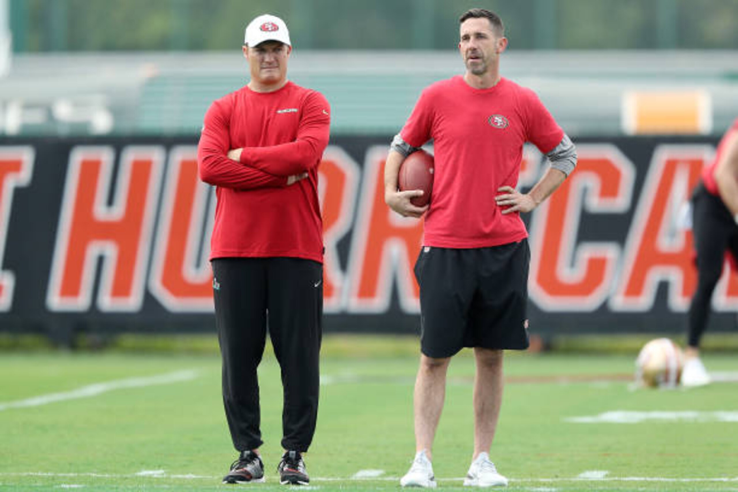 CORAL GABLES, FLORIDA - JANUARY 29:  Head coach Kyle Shanahan of the San Francisco 49ers (R) talks with general manager John Lynch during practice for Super Bowl LIV at the Greentree Practice Fields on the campus of the University of Miami on January 29, 2020 in Coral Gables, Florida. (Photo by Michael Reaves/Getty Images)
