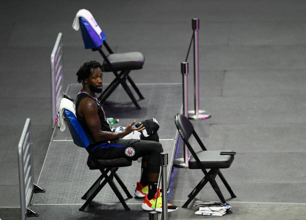 LOS ANGELES, CALIFORNIA - APRIL 08: Patrick Beverley #21 of the LA Clippers on the bench on his own during the first quarter against the Phoenix Suns at Staples Center on April 08, 2021 in Los Angeles, California. (Photo by Harry How/Getty Images) NOTE TO USER: User expressly acknowledges and agrees that, by downloading and or using this photograph, User is consenting to the terms and conditions of the Getty Images License Agreement.