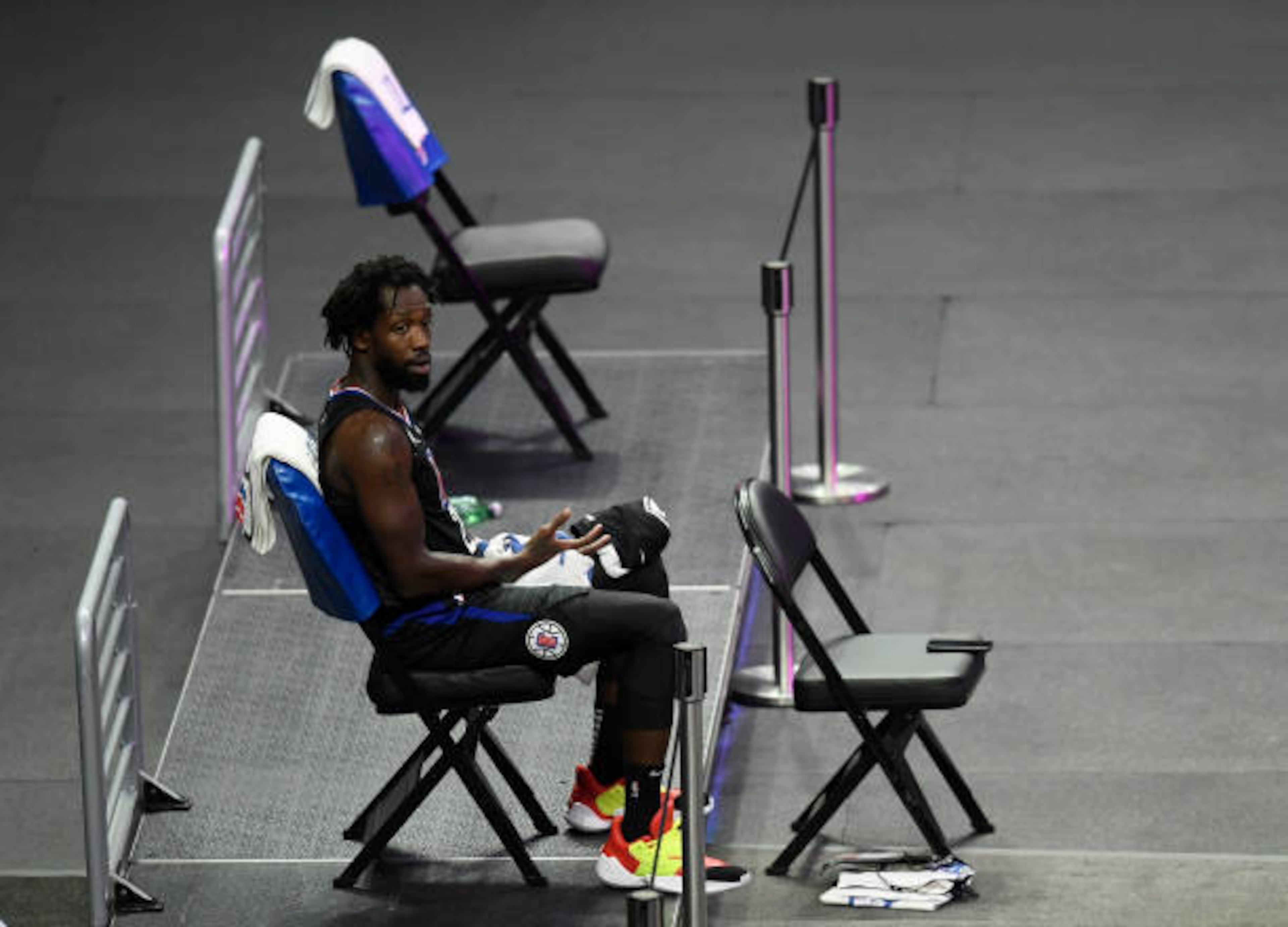 LOS ANGELES, CALIFORNIA - APRIL 08: Patrick Beverley #21 of the LA Clippers on the bench on his own during the first quarter against the Phoenix Suns at Staples Center on April 08, 2021 in Los Angeles, California. (Photo by Harry How/Getty Images) NOTE TO USER: User expressly acknowledges and agrees that, by downloading and or using this photograph, User is consenting to the terms and conditions of the Getty Images License Agreement.