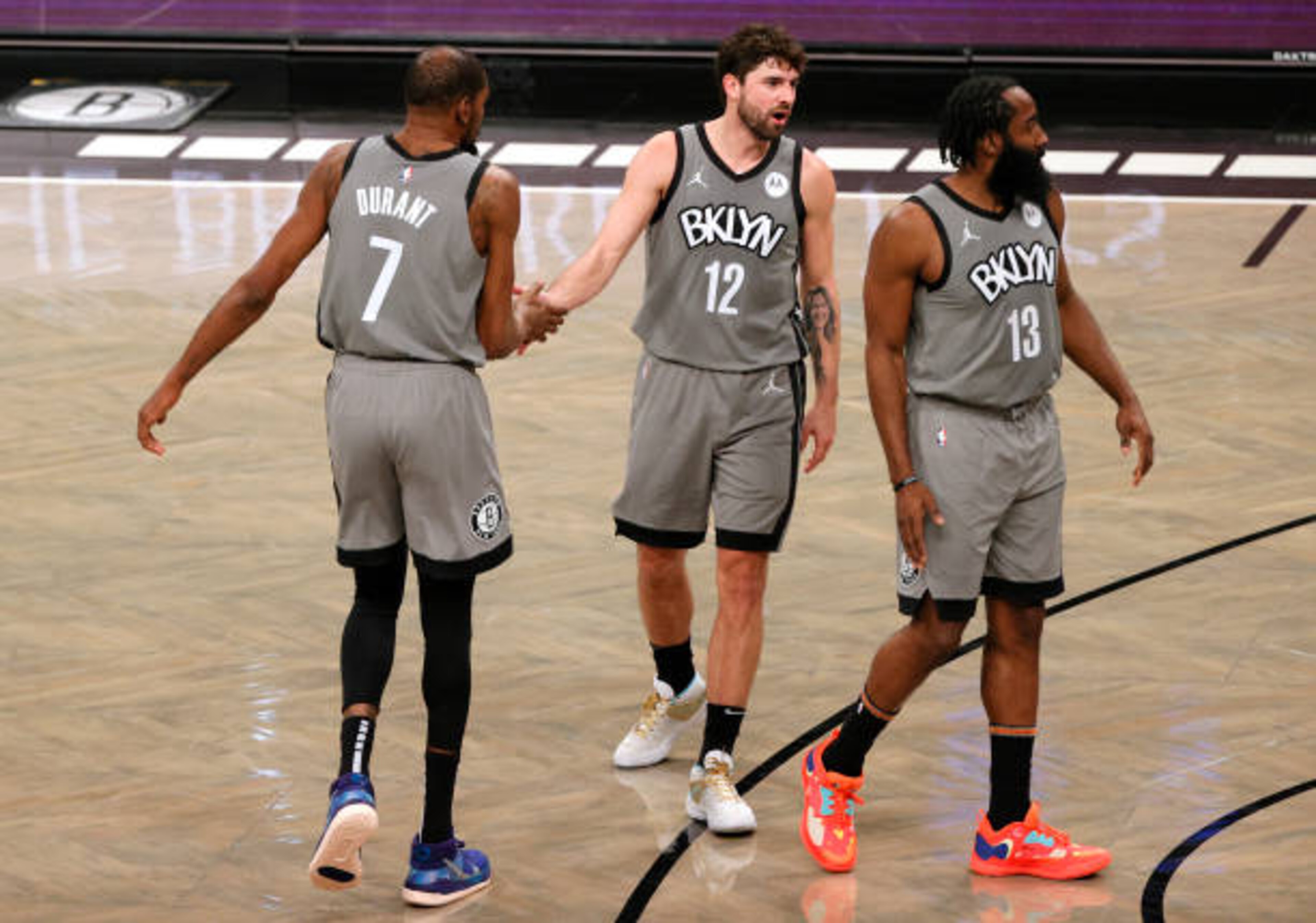 NEW YORK, NEW YORK - JANUARY 25: Kevin Durant #7 high fives Joe Harris #12 as James Harden #13 of the Brooklyn Nets looks on during the second half against the Miami Heat at Barclays Center on January 25, 2021 in the Brooklyn borough of New York City. The Nets won 98-85. NOTE TO USER: User expressly acknowledges and agrees that, by downloading and or using this Photograph, user is consenting to the terms and conditions of the Getty Images License Agreement. (Photo by Sarah Stier/Getty Images) NEW YORK, NEW YORK - JANUARY 25: Kevin Durant #7 high fives Joe Harris #12 as James Harden #13 of the Brooklyn Nets looks on during the second half against the Miami Heat at Barclays Center on January 25, 2021 in the Brooklyn borough of New York City. The Nets won 98-85. NOTE TO USER: User expressly acknowledges and agrees that, by downloading and or using this Photograph, user is consenting to the terms and conditions of the Getty Images License Agreement. (Photo by Sarah Stier/Getty Images)