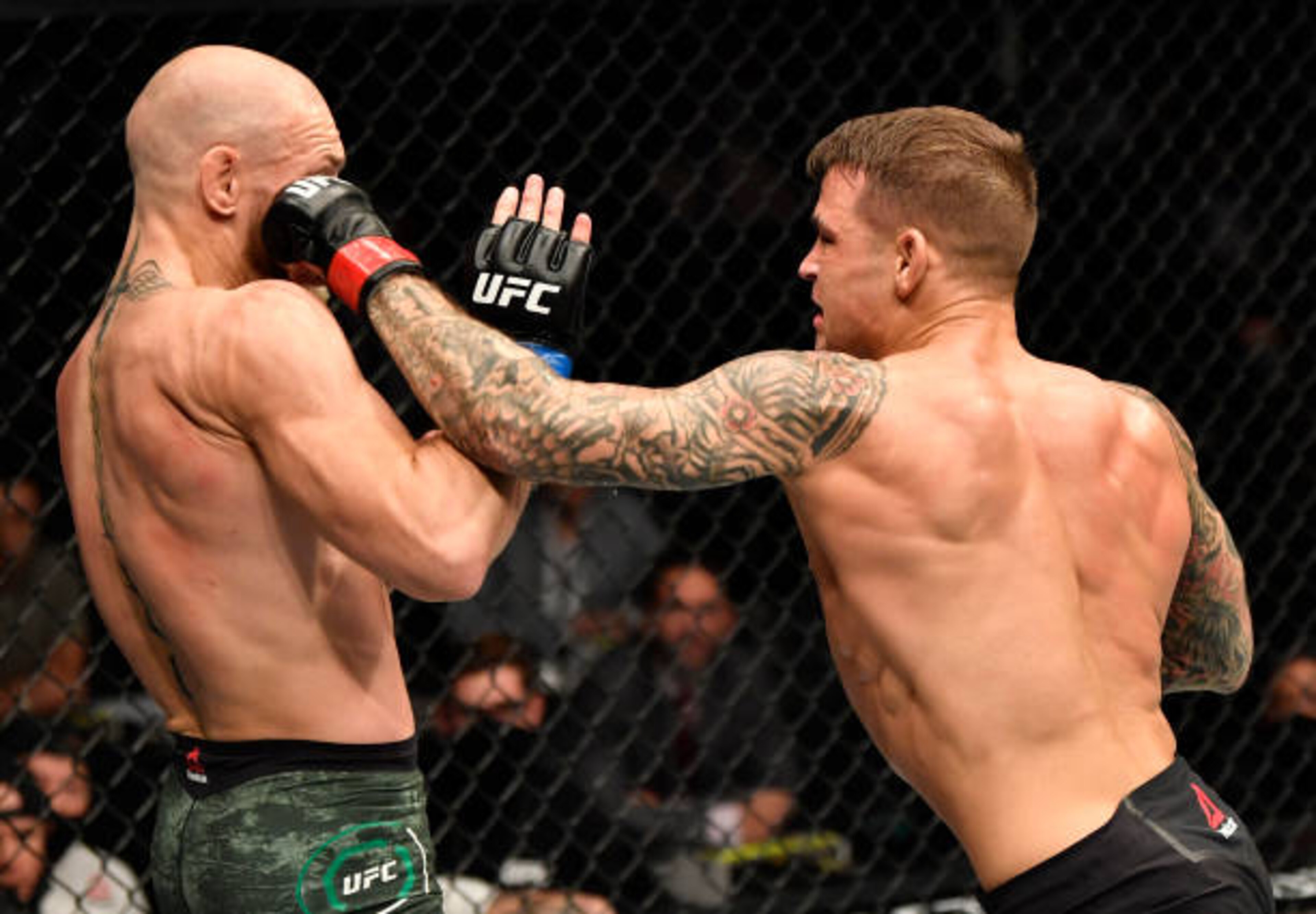 ABU DHABI, UNITED ARAB EMIRATES - JANUARY 23: In this handout image provided by the UFC, (R-L) Dustin Poirier punches Conor McGregor of Ireland in a lightweight fight during the UFC 257 event inside Etihad Arena on UFC Fight Island on January 23, 2021 in Abu Dhabi, United Arab Emirates. (Photo by Jeff Bottari/Zuffa LLC via Getty Images)