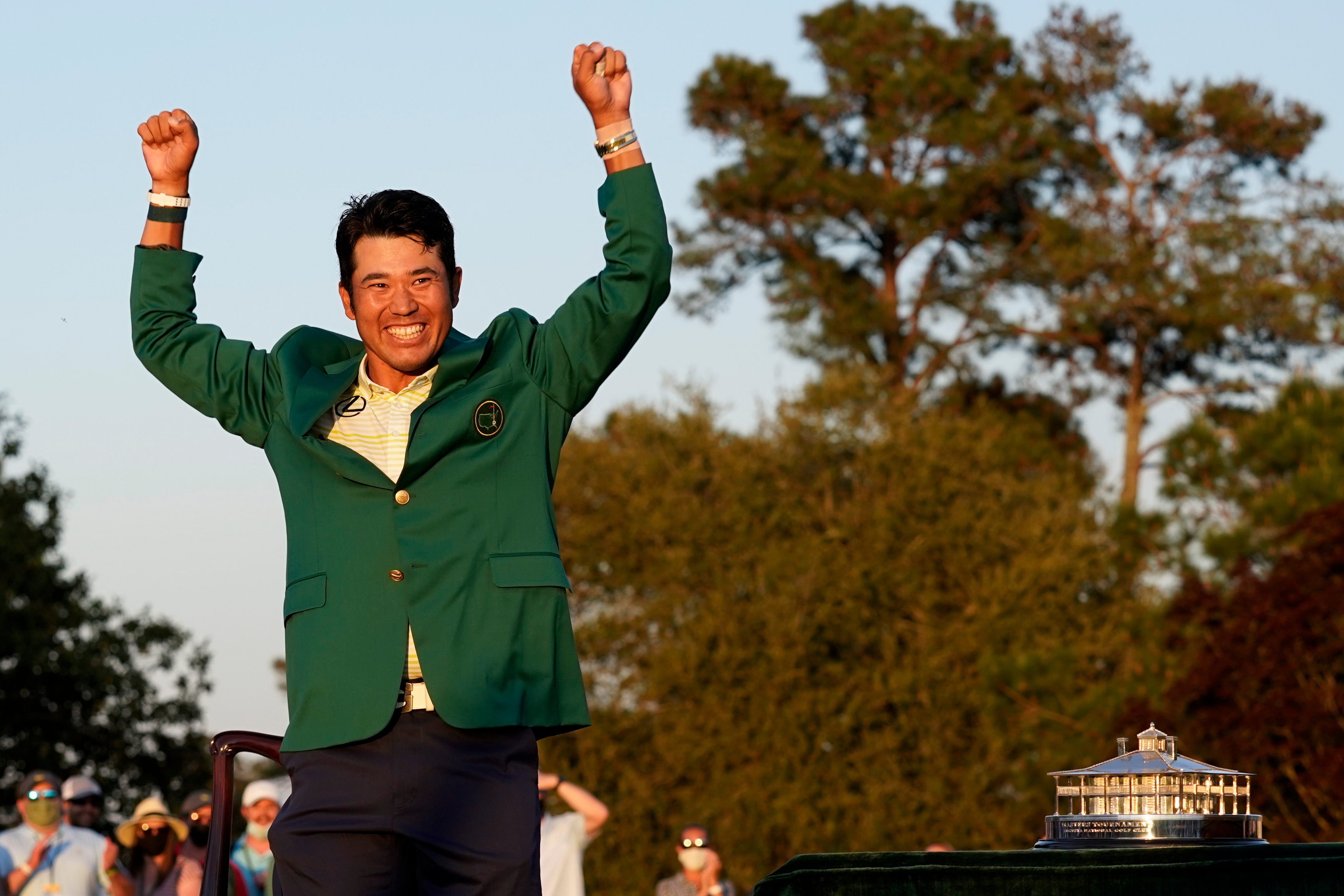 Hideki Matsuyama, of Japan, celebrates after putting on the champion's green jacket after winning the Masters golf tournament on Sunday, April 11, 2021, in Augusta, Ga. (AP Photo/Gregory Bull)