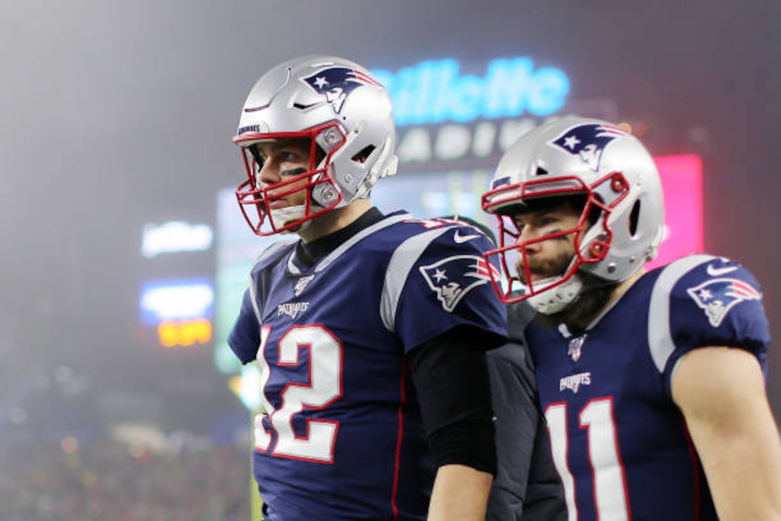 FOXBOROUGH, MASSACHUSETTS - JANUARY 04: Tom Brady #12 of the New England Patriots and Julian Edelman #11 look on after Edelman scored a touchdown in the second quarter of the AFC Wild Card Playoff game at Gillette Stadium on January 04, 2020 in Foxborough, Massachusetts. (Photo by Maddie Meyer/Getty Images)
