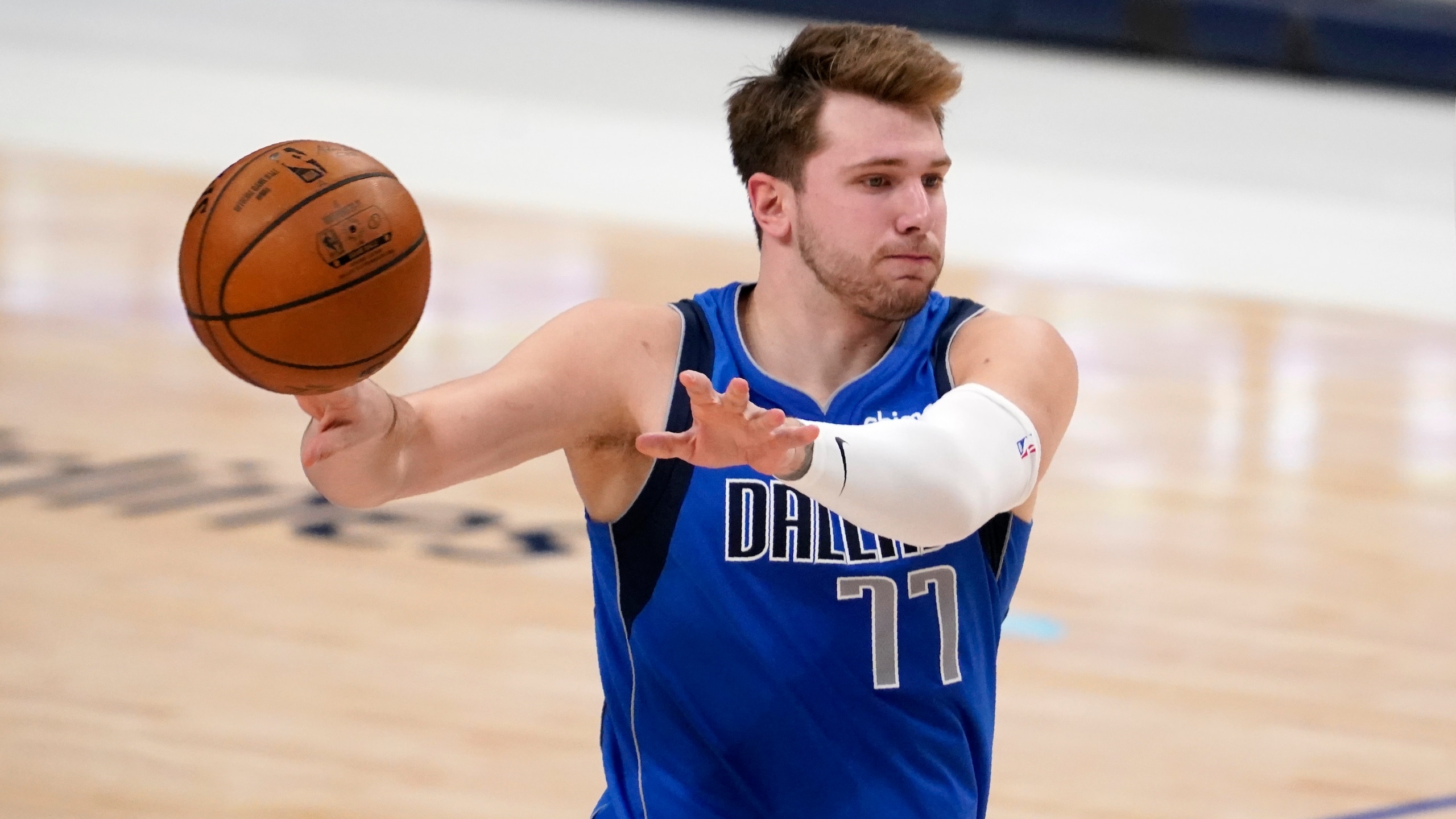 Dallas Mavericks guard Luka Doncic makes a pass in the second half of an NBA basketball game against the San Antonio Spurs in Dallas, Sunday, April 11, 2021. (AP Photo/Tony Gutierrez)