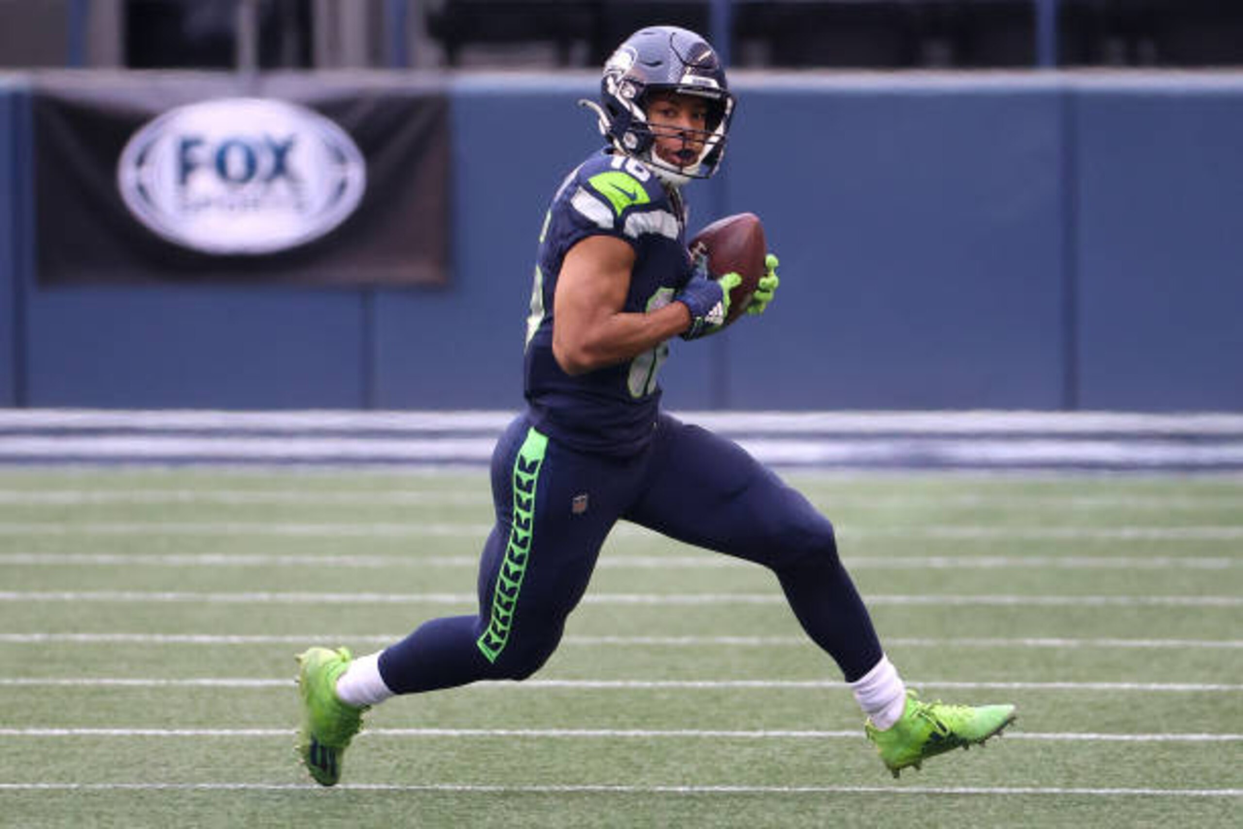 SEATTLE, WASHINGTON - JANUARY 09: Tyler Lockett #16 of the Seattle Seahawks runs with the ball in the second quarter against the Los Angeles Rams during the NFC Wild Card Playoff game at Lumen Field on January 09, 2021 in Seattle, Washington. (Photo by Abbie Parr/Getty Images)