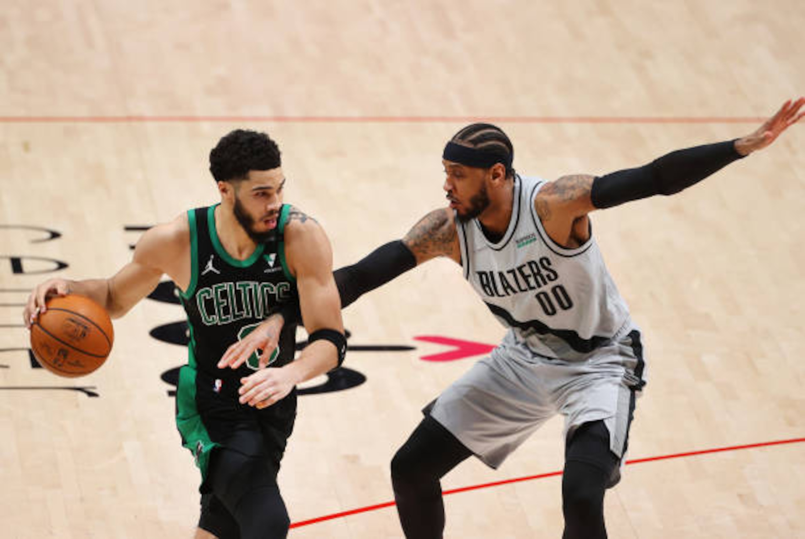 PORTLAND, OREGON - APRIL 13: Jayson Tatum #0 of the Boston Celtics works against Carmelo Anthony #00 of the Portland Trail Blazers in the third quarter at Moda Center on April 13, 2021 in Portland, Oregon. NOTE TO USER: User expressly acknowledges and agrees that, by downloading and or using this photograph, User is consenting to the terms and conditions of the Getty Images License Agreement. (Photo by Abbie Parr/Getty Images)