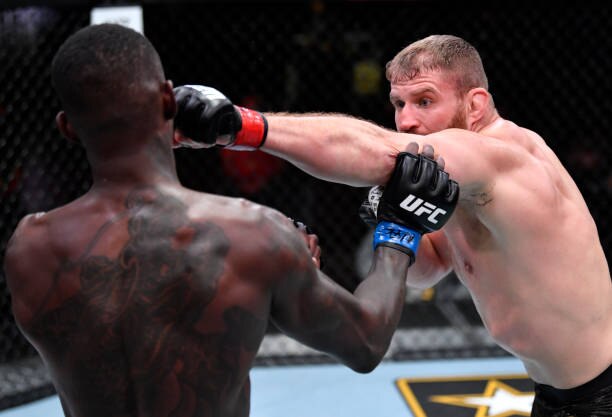 LAS VEGAS, NEVADA - MARCH 06: (R-L) Jan Blachowicz of Poland punches Israel Adesanya of Nigeria in their UFC light heavyweight championship fight during the UFC 259 event at UFC APEX on March 06, 2021 in Las Vegas, Nevada. (Photo by Jeff Bottari/Zuffa LLC)