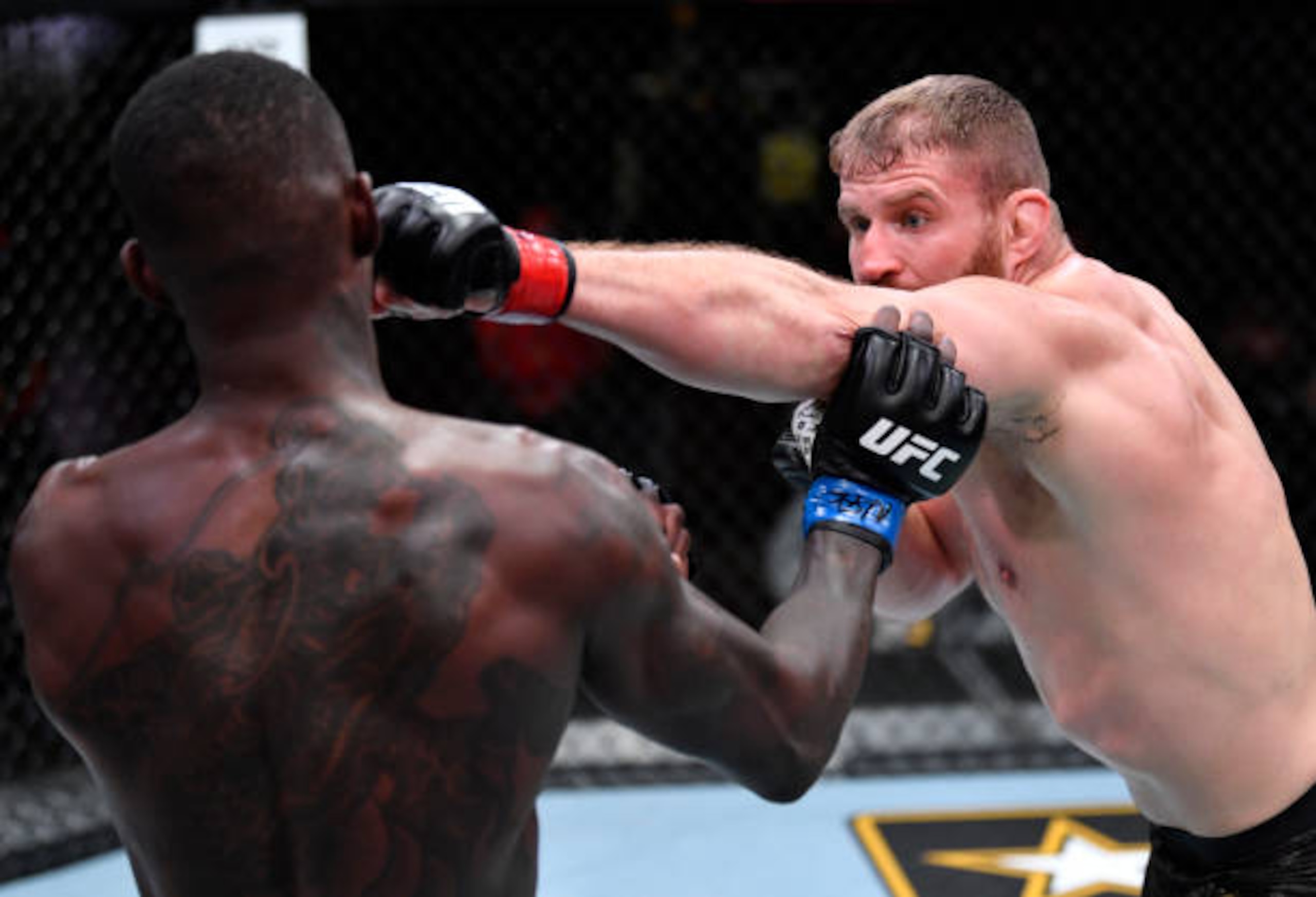 LAS VEGAS, NEVADA - MARCH 06: (R-L) Jan Blachowicz of Poland punches Israel Adesanya of Nigeria in their UFC light heavyweight championship fight during the UFC 259 event at UFC APEX on March 06, 2021 in Las Vegas, Nevada. (Photo by Jeff Bottari/Zuffa LLC)