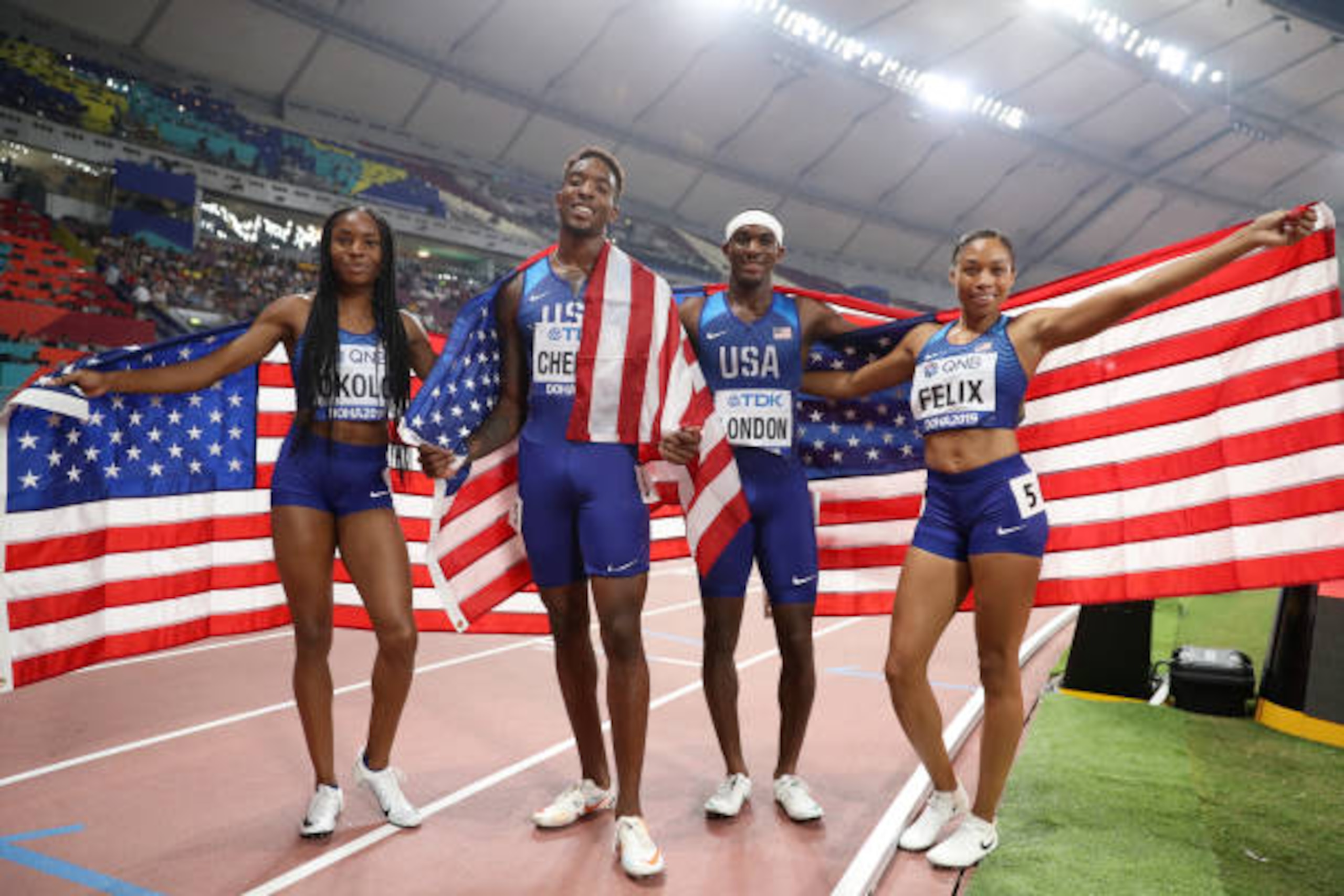 Track & Field: IAAF World Athletics Championships: (L-R) USA Allyson Felix, Wilbert London, Michael Cherry, and Courtney Okolo victorious with flag after breaking world record in the Mixed Relay 4X400M final race at Khalifa International Stadium. Mixed Relay will be a new event in Tokyo Olympics 2020.
Doha, Qatar 9/29/2019
CREDIT: Simon Bruty (Photo by Simon Bruty /Sports Illustrated/Getty Images)
(Set Number: X162932 TK1 )