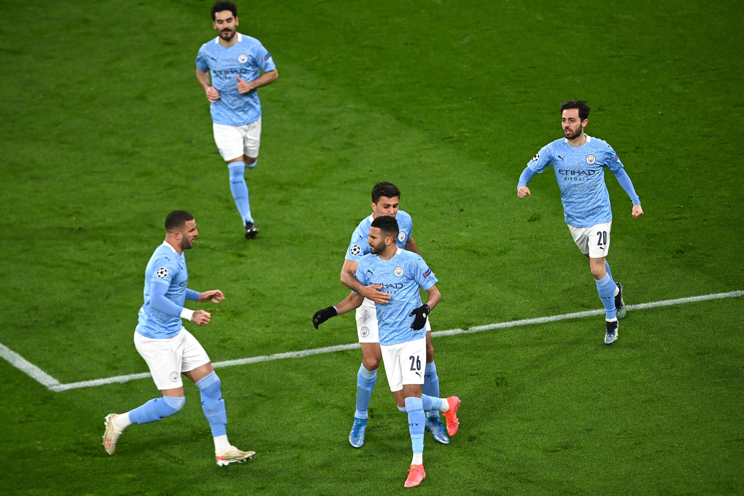 Manchester City's Riyad Mahrez celebrates after scoring his side's first goal during the Champions League quarterfinal second leg soccer match between Borussia Dortmund and Manchester City at the Signal Iduna Park stadium in Dortmund, Germany, Wednesday, April 14, 2021. (Federico Gambarini/Pool via AP)