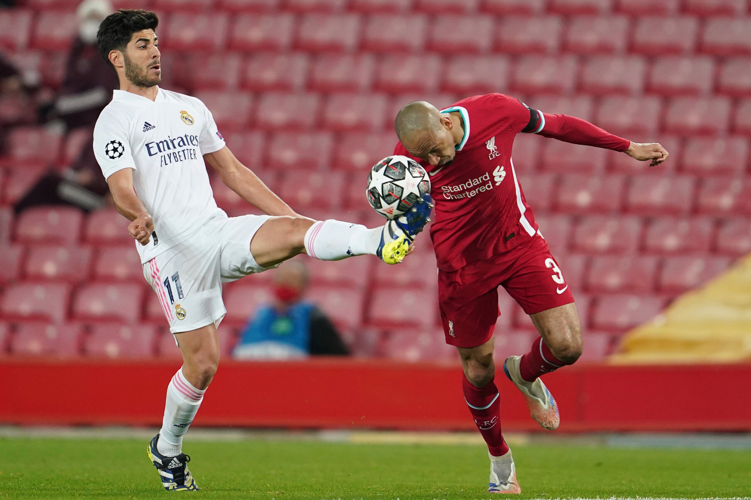 Real Madrid's Marco Asensio, fights for the ball with Liverpool's Fabinho during a Champions League quarter final second leg soccer match between Liverpool and Real Madrid at Anfield stadium in Liverpool, England, Wednesday, April 14, 2021. (AP Photo/Jon Super)