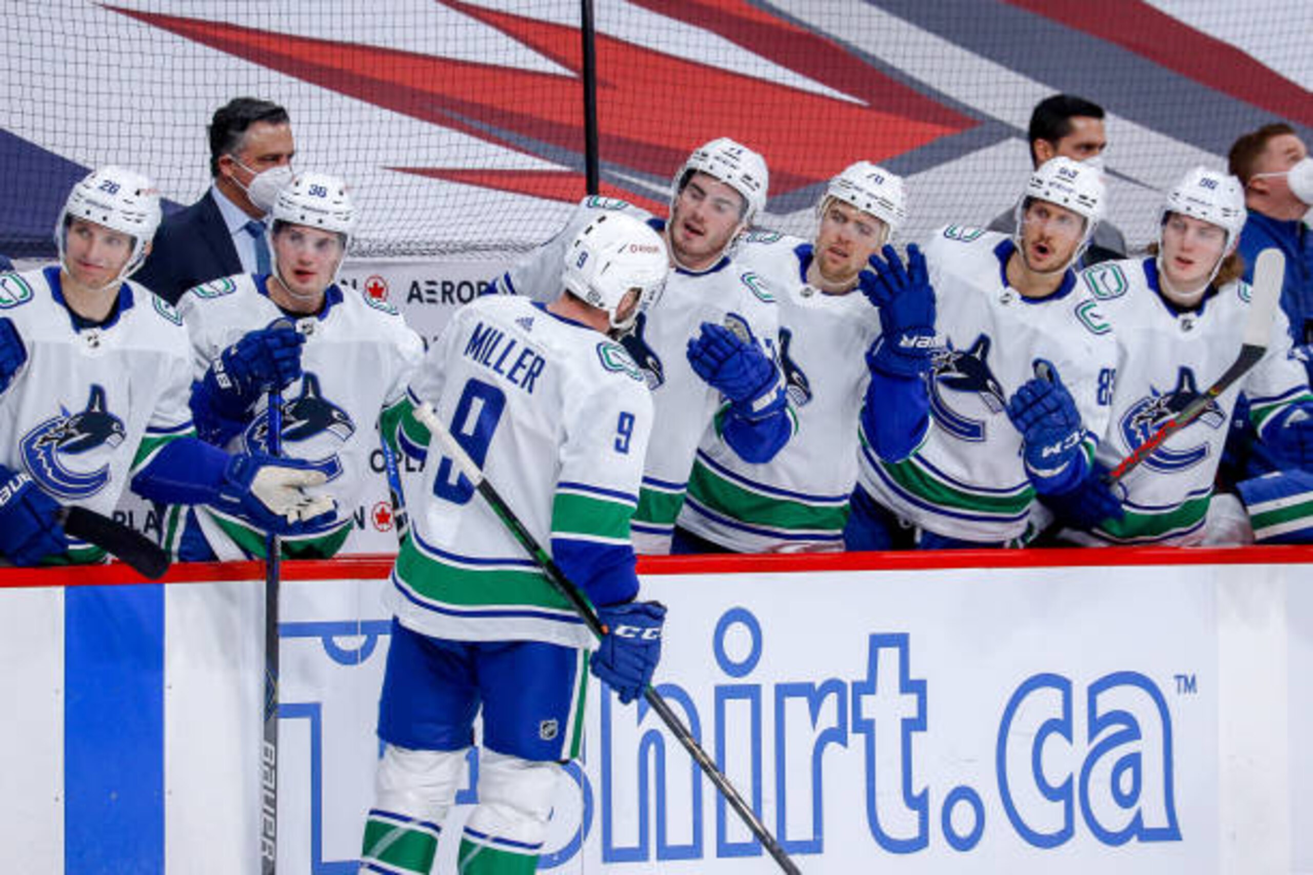 WINNIPEG, MB - MARCH 2: J.T. Miller #9 of the Vancouver Canucks celebrates his second period goal against the Winnipeg Jets with teammates at the bench at the Bell MTS Place on March 2, 2021 in Winnipeg, Manitoba, Canada. (Photo by Darcy Finley/NHLI via Getty Images)