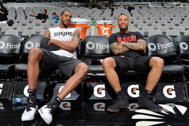 SAN ANTONIO, TX - MARCH 16: LaMarcus Aldridge #12 of the San Antonio Spurs and Damian Lillard #0 of the Portland Trail Blazers talks before the game on March 16, 2019 at the AT&T Center in San Antonio, Texas. NOTE TO USER: User expressly acknowledges and agrees that, by downloading and or using this photograph, user is consenting to the terms and conditions of the Getty Images License Agreement. Mandatory Copyright Notice: Copyright 2019 NBAE (Photos by Mark Sobhani/NBAE via Getty Images)
