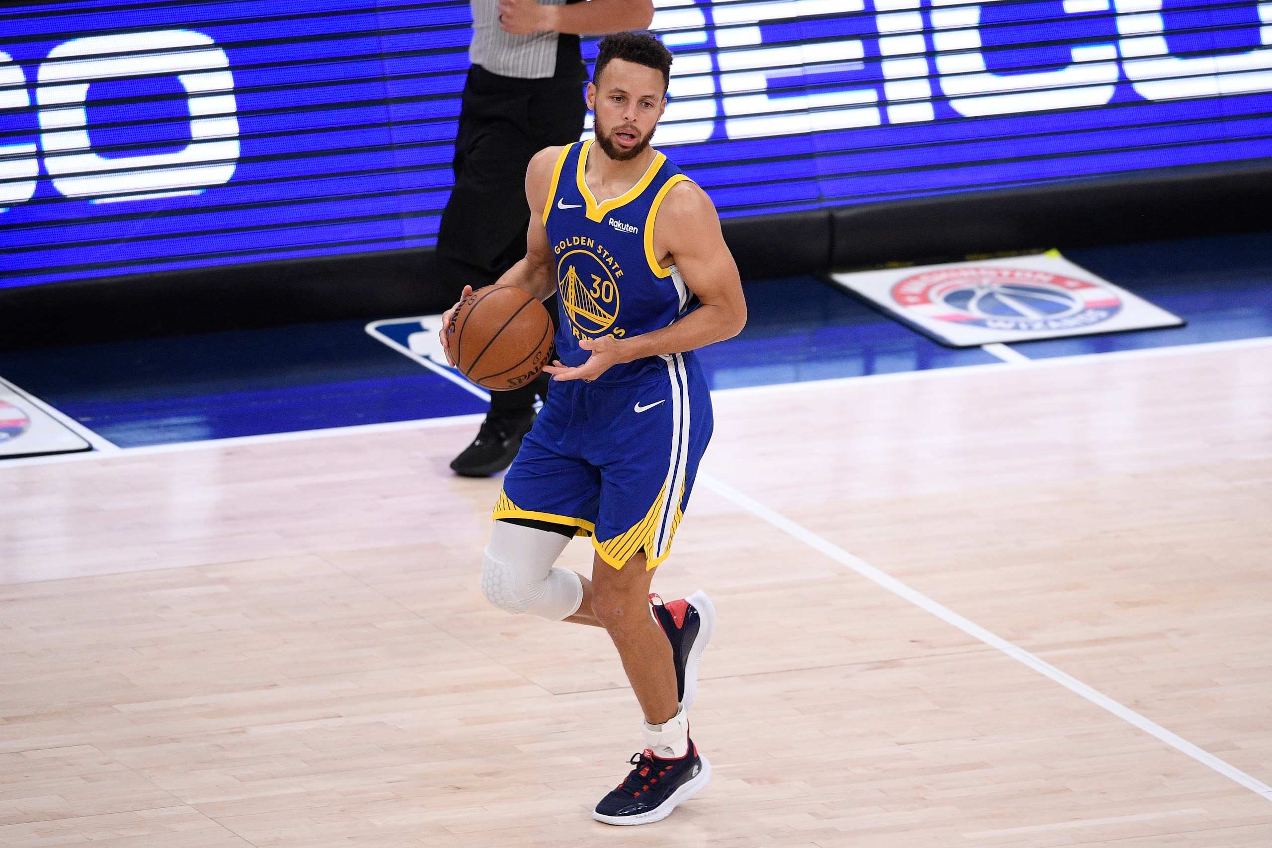 Golden State Warriors guard Stephen Curry (30) dribbles the ball during the second half of an NBA basketball game against the Washington Wizards, Wednesday, April 21, 2021, in Washington. (AP Photo/Nick Wass)