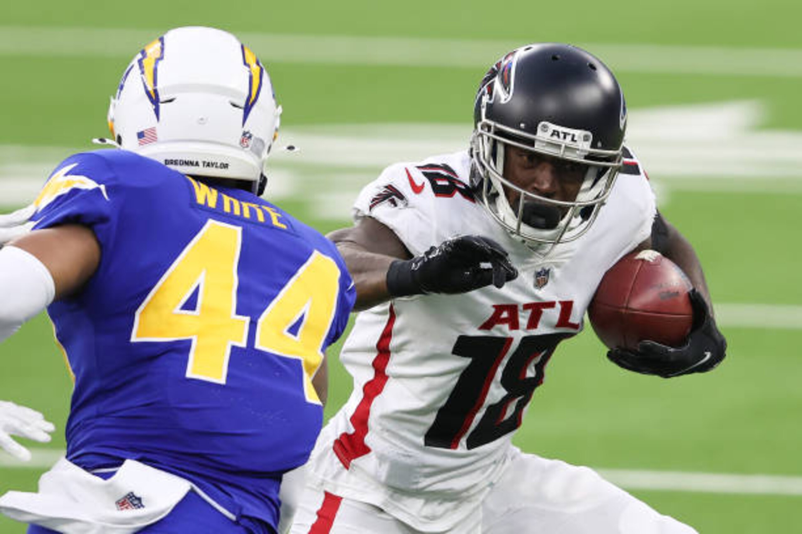 INGLEWOOD, CALIFORNIA - DECEMBER 13:  Calvin Ridley #18 of the Atlanta Falcons carries the ball after a reception against Kyzir White #44 of the Los Angeles Chargers during the fourth quarter at SoFi Stadium on December 13, 2020 in Inglewood, California. (Photo by Sean M. Haffey/Getty Images)