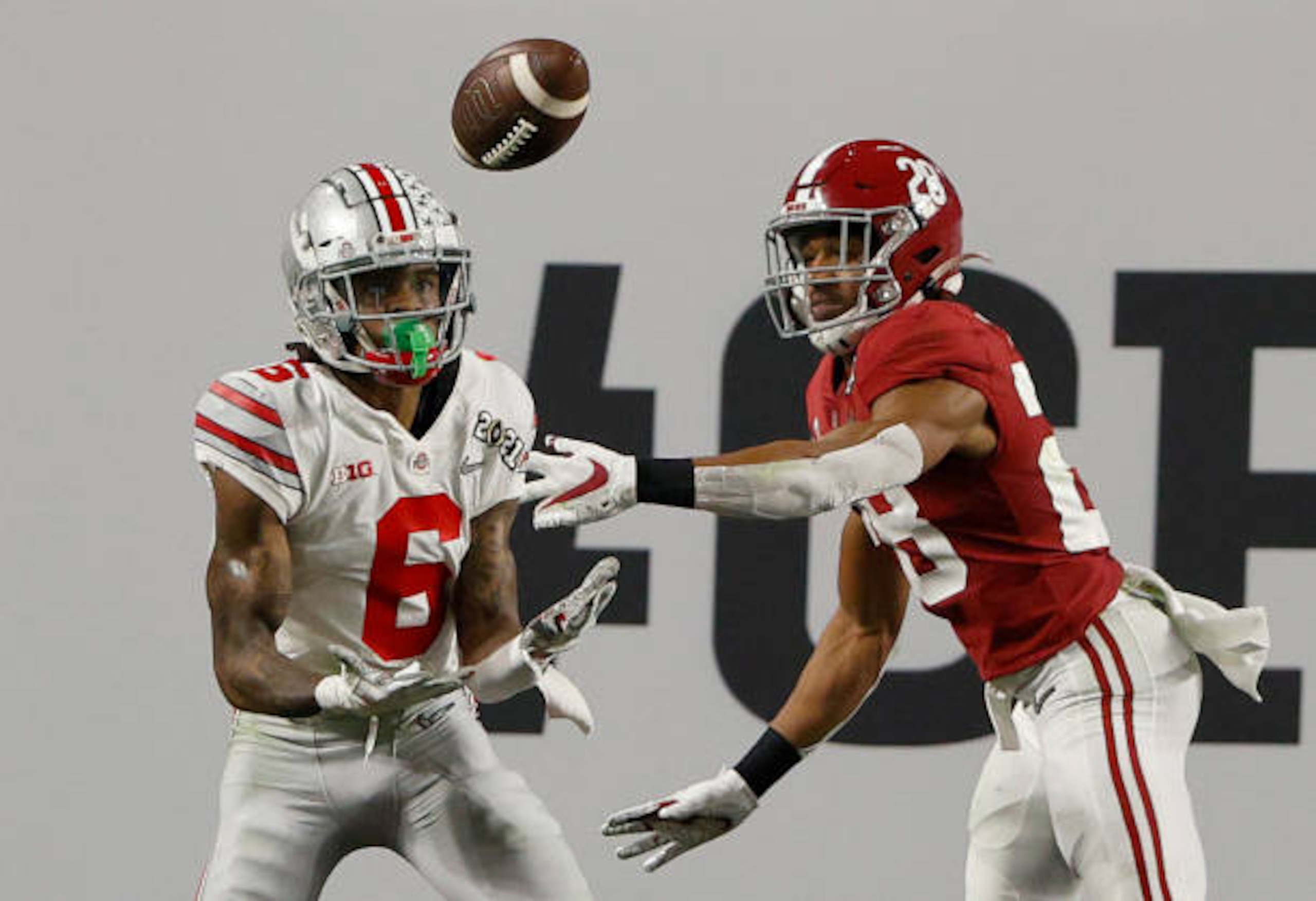 MIAMI GARDENS, FLORIDA - JANUARY 11: Jameson Williams #6 of the Ohio State Buckeyes attempts a reception against Josh Jobe #28 of thee Alabama Crimson Tide during the CFP National Championship Presented by AT&T at Hard Rock Stadium on January 11, 2021 in Miami Gardens, Florida. (Photo by Sam Greenwood/Getty Images)