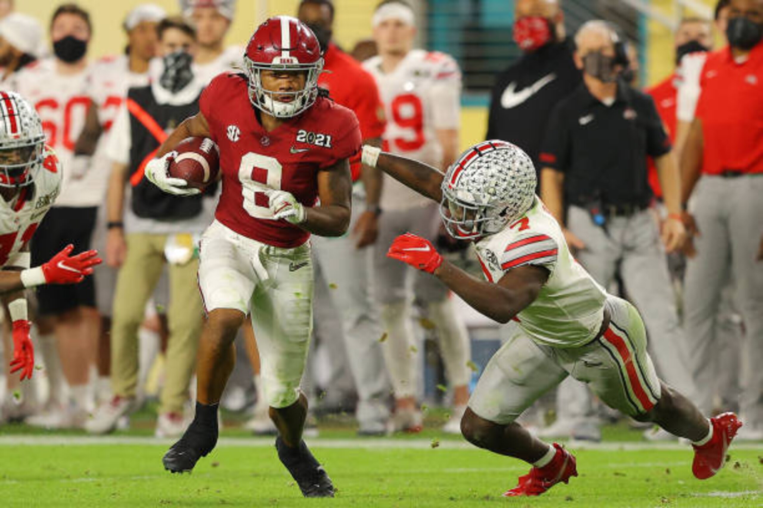 MIAMI GARDENS, FLORIDA - JANUARY 11: John Metchie III #8 of the Alabama Crimson Tide rushes ahead of Sevyn Banks #7 of the Ohio State Buckeyes during the fourth quarter of the College Football Playoff National Championship game at Hard Rock Stadium on January 11, 2021 in Miami Gardens, Florida. (Photo by Kevin C. Cox/Getty Images)