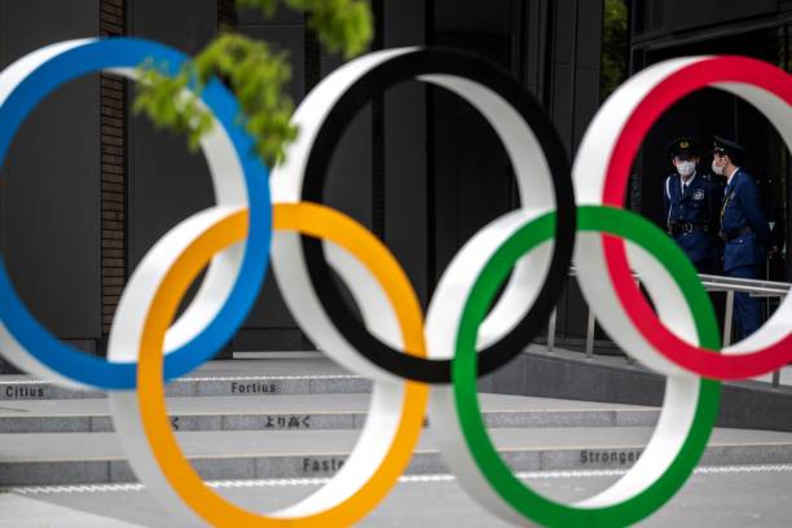 Security guards are seen through the Olympic Rings near the National Stadium for the Tokyo 2020 Olympic and Paralympic Games, in Tokyo on April 28, 2021. (Photo by CHARLY TRIBALLEAU / AFP) (Photo by CHARLY TRIBALLEAU/AFP via Getty Images) Security guards are seen through the Olympic Rings near the National Stadium for the Tokyo 2020 Olympic and Paralympic Games, in Tokyo on April 28, 2021. (Photo by CHARLY TRIBALLEAU / AFP) (Photo by CHARLY TRIBALLEAU/AFP via Getty Images)