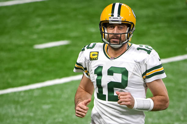 DETROIT, MICHIGAN - DECEMBER 13: Aaron Rodgers #12 of the Green Bay Packers runs off the field during the first half against the Detroit Lions at Ford Field on December 13, 2020 in Detroit, Michigan. (Photo by Nic Antaya/Getty Images)